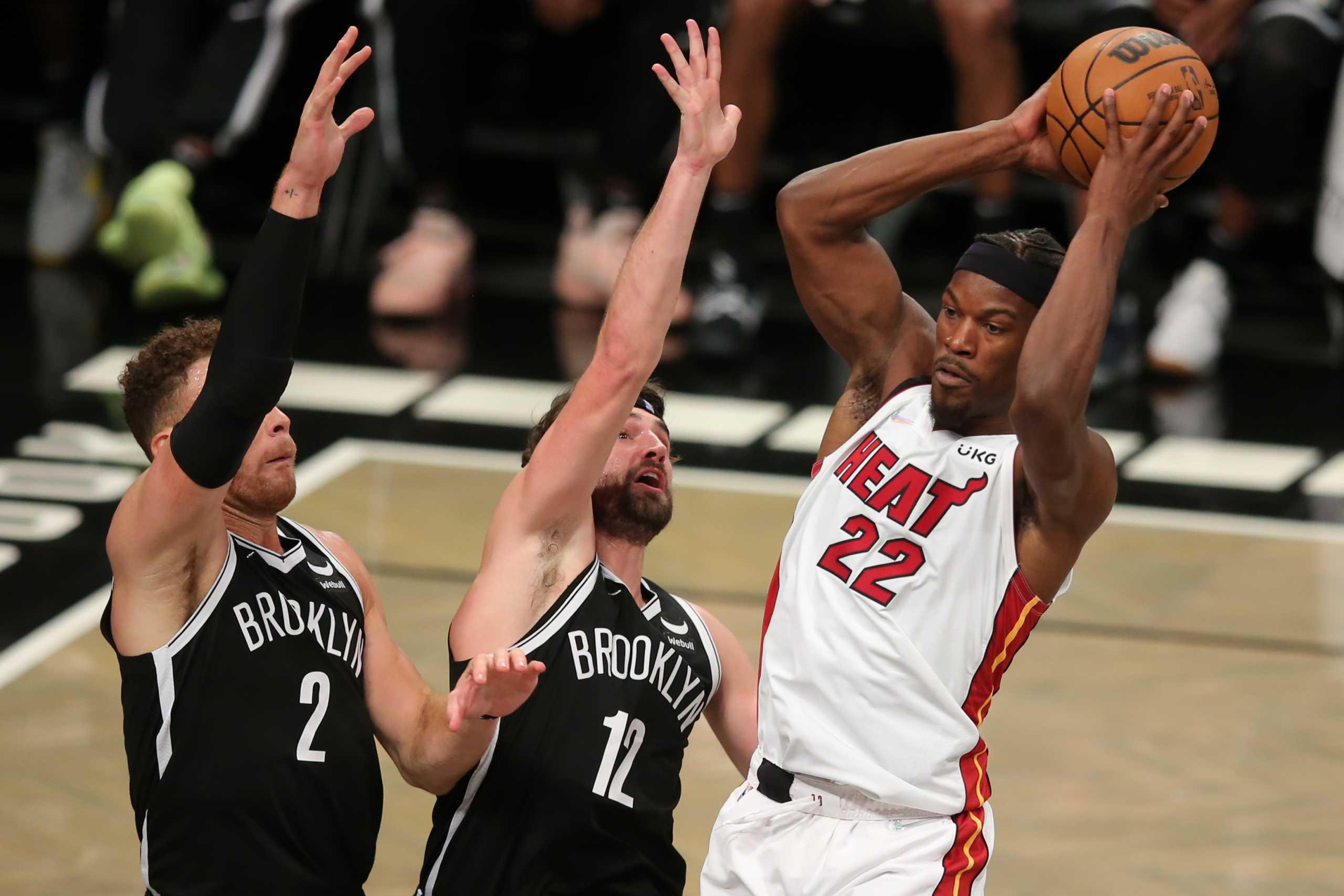 Oct 27, 2021; Brooklyn, New York, USA; Miami Heat forward Jimmy Butler (22) controls the ball against Brooklyn Nets forward Blake Griffin (2) and forward Joe Harris (12) during the third quarter at Barclays Center. Mandatory Credit: Brad Penner-USA TODAY Sports