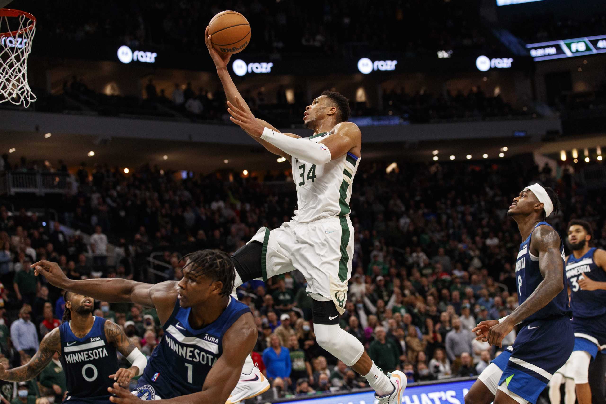 Oct 27, 2021; Milwaukee, Wisconsin, USA;  Milwaukee Bucks forward Giannis Antetokounmpo (34) drives for the basket over Minnesota Timberwolves guard Anthony Edwards (1) during the fourth quarter at Fiserv Forum. Mandatory Credit: Jeff Hanisch-USA TODAY Sports