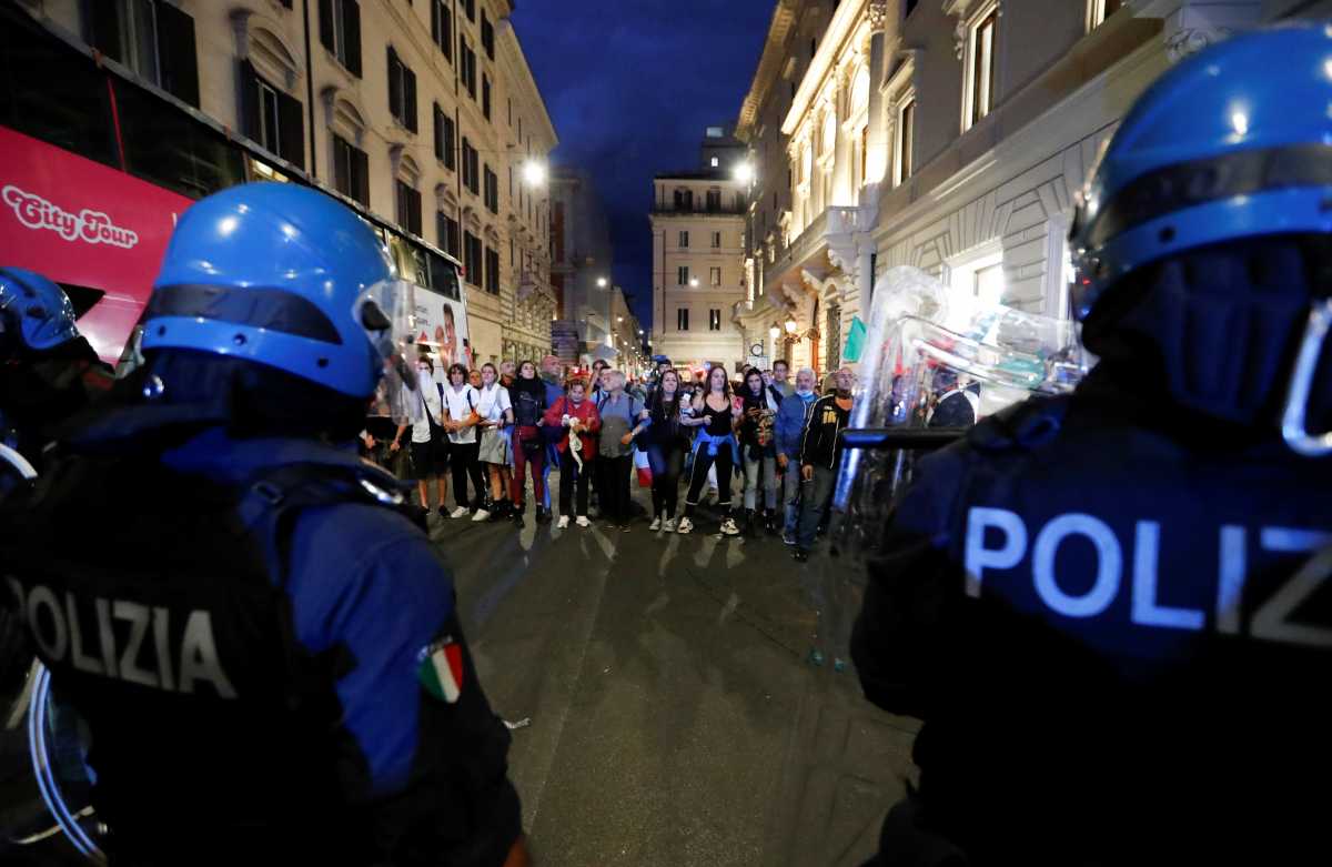 Demonstrators face off police officers during a protest against the government's introduction of the "Green Pass" near Chigi Palace in Rome, Italy, October 9, 2021. REUTERS