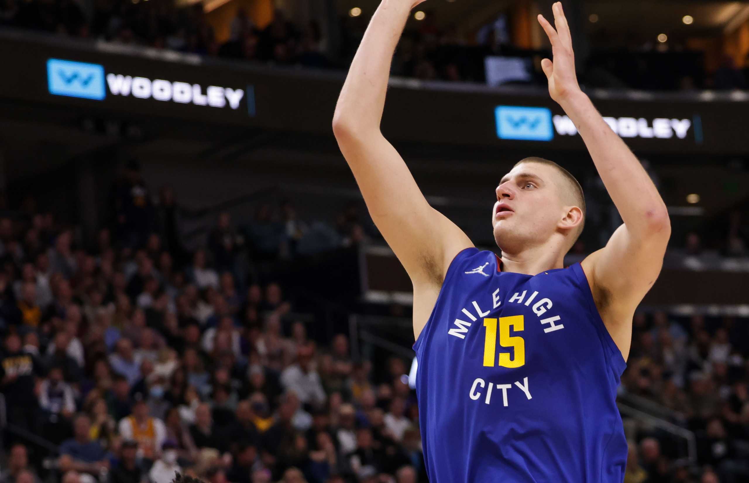 Oct 26, 2021; Salt Lake City, Utah, USA;  Denver Nuggets center Nikola Jokic (15) shoots the ball over Utah Jazz guard Donovan Mitchell (45) during the second quarter at Vivint Arena. Mandatory Credit: Chris Nicoll-USA TODAY Sports