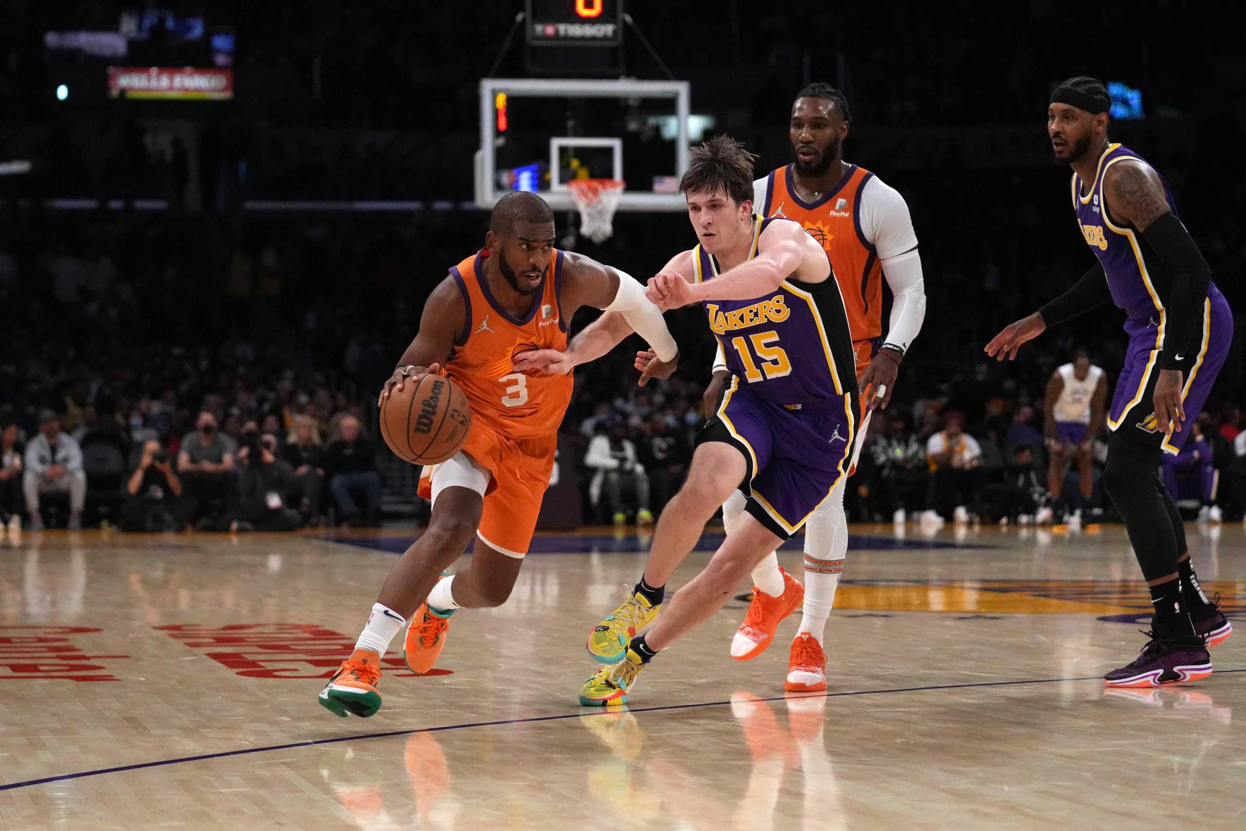 Oct 22, 2021; Los Angeles, California, USA; Phoenix Suns guard Chris Paul (3) is defended by Los Angeles Lakers guard Austin Reaves (15) in the second half at Staples Center. The Suns defeated the Lakers 115-105. Mandatory Credit: Kirby Lee-USA TODAY Sports