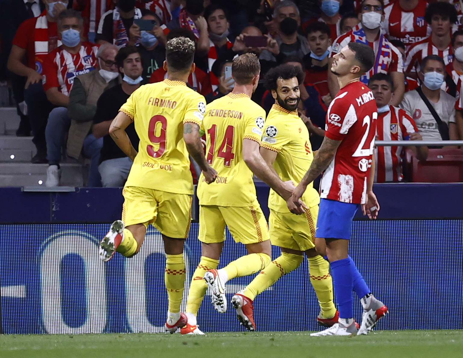 Soccer Football - Champions League - Group B - Atletico Madrid v Liverpool - Wanda Metropolitano, Madrid, Spain - October 19, 2021 Liverpool's Mohamed Salah celebrates scoring their third goal with Roberto Firmino and Jordan Henderson REUTERS
