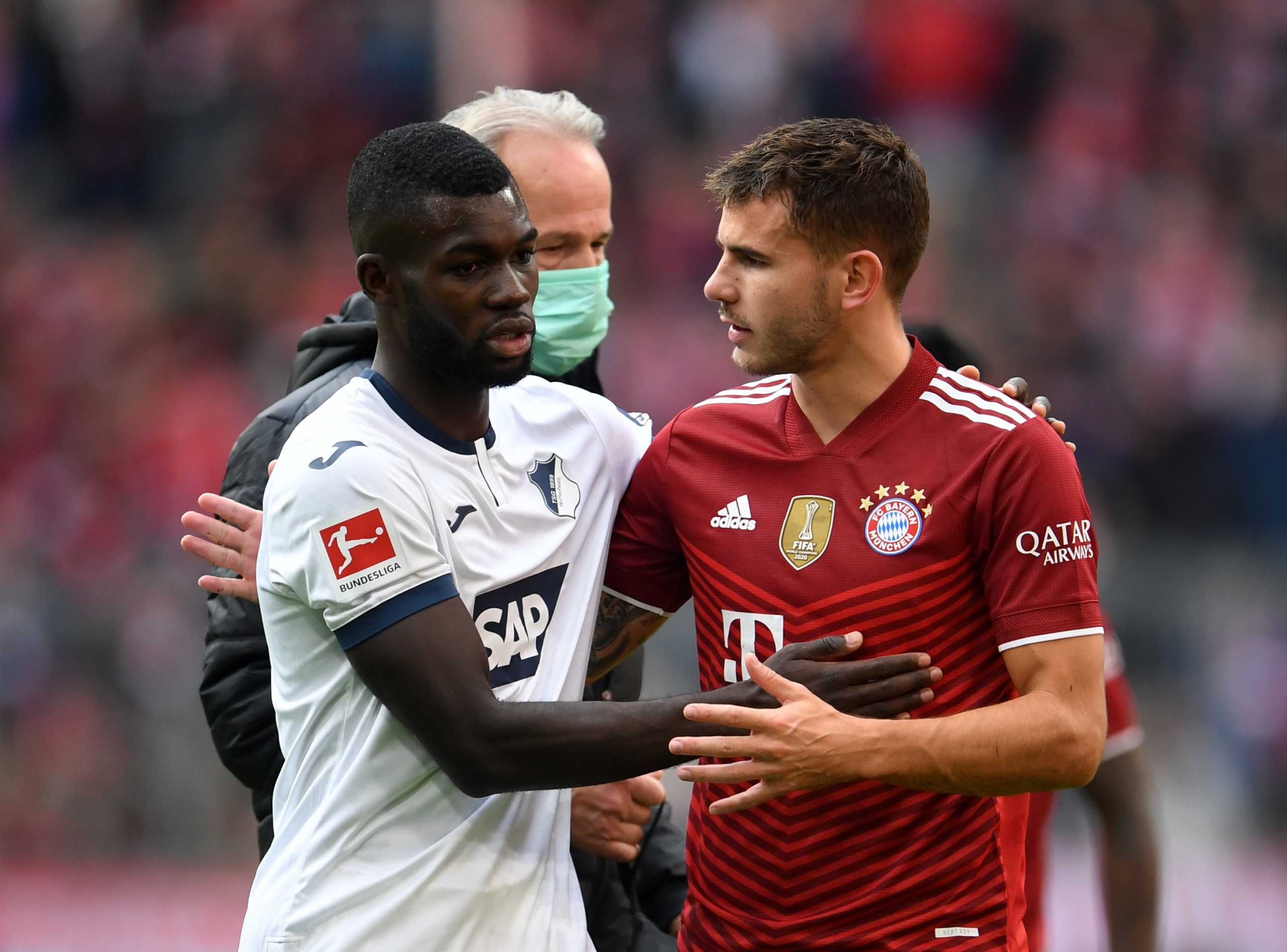 Soccer Football - Bundesliga - Bayern Munich v TSG 1899 Hoffenheim - Allianz Arena, Munich, Germany - October 23, 2021  TSG 1899 Hoffenheim's Ihlas Bebou with Bayern Munich's Lucas Hernandez REUTERS