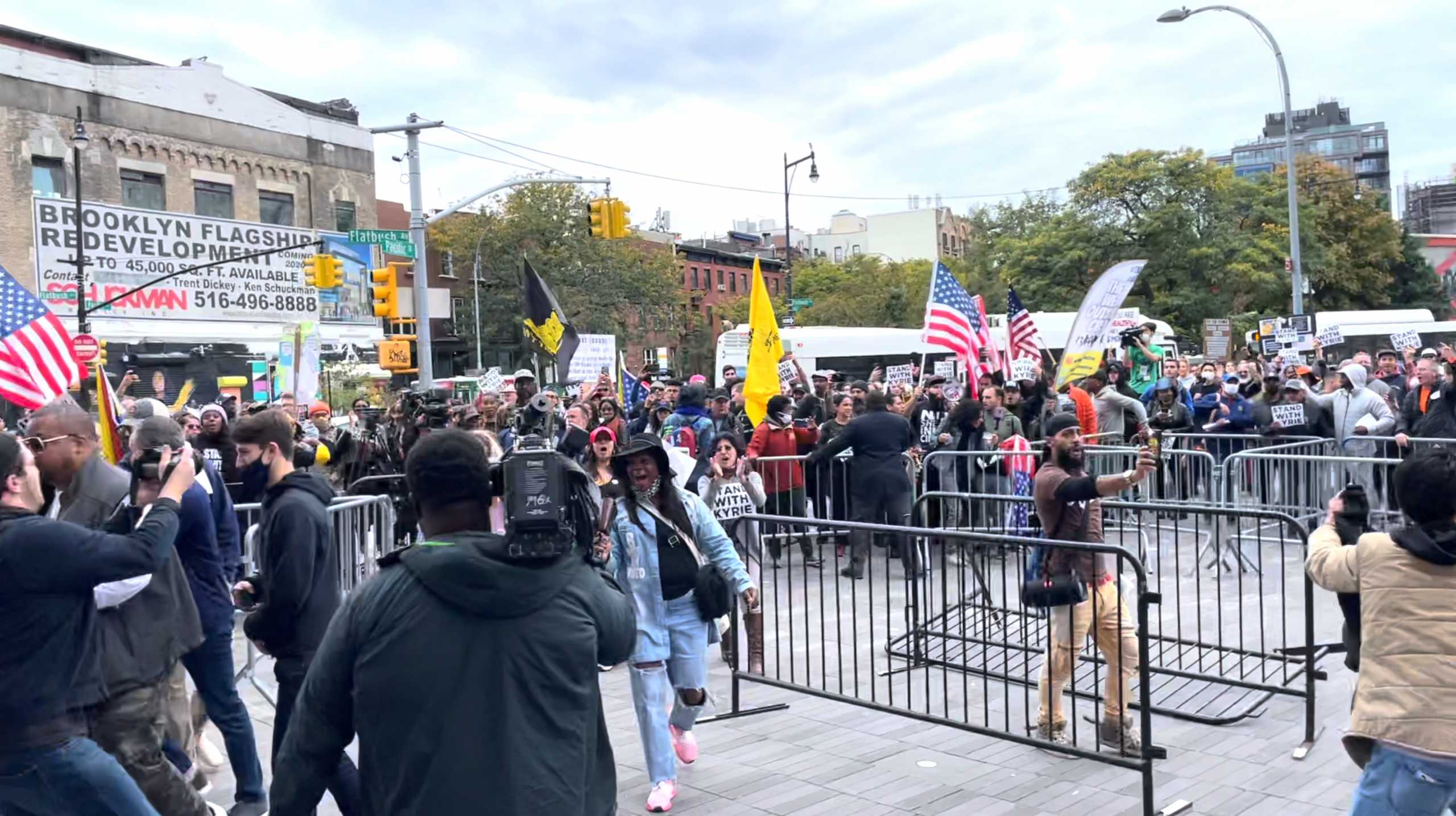 Demonstrators shout slogans outside the Barclays Center, amid the coronavirus disease (COVID-19) pandemic following Brooklyn's Kyrie Irving refusal of vaccination for the COVID-19, in New York, U.S., October 24, 2021, in this screen grab obtained from a social media video. TWITTER