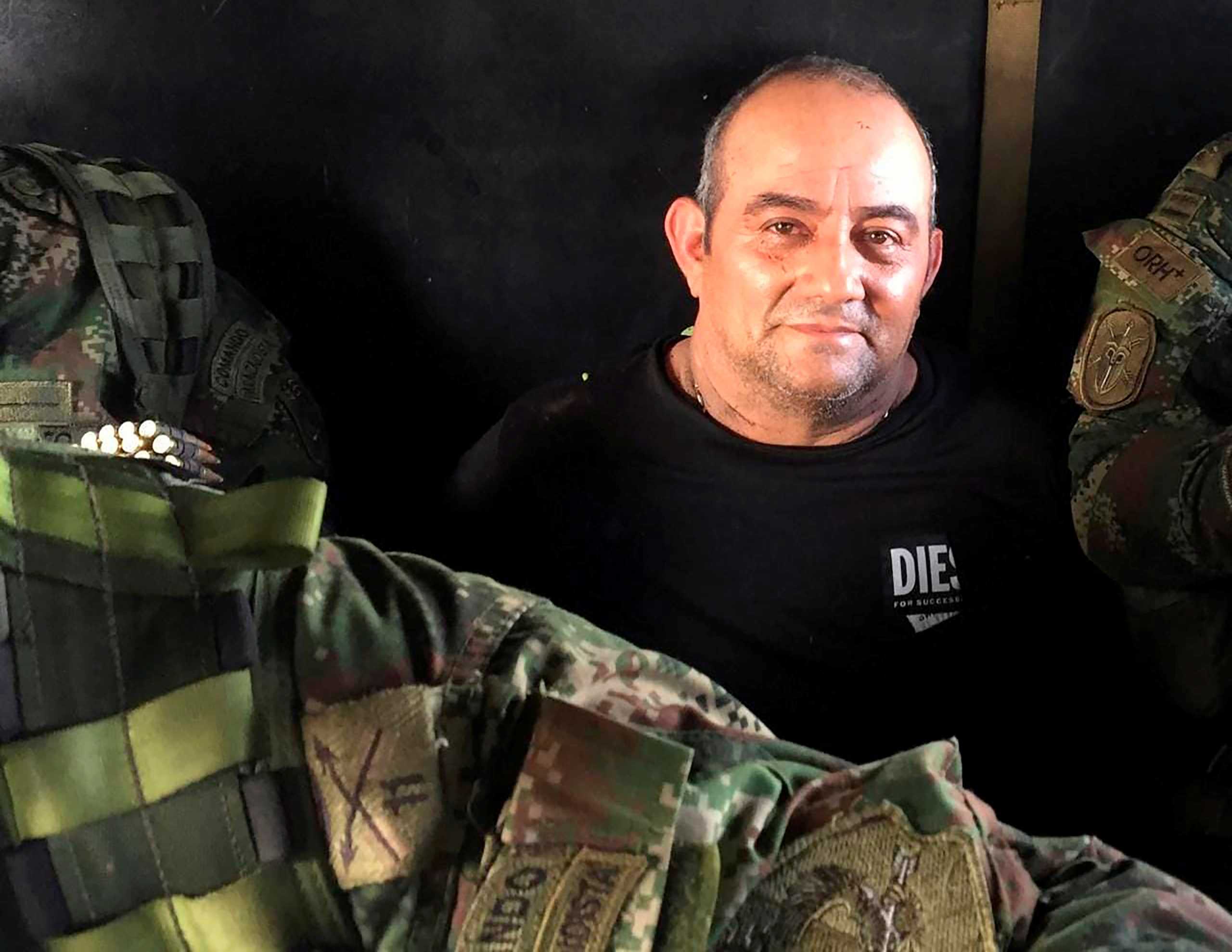 Dairo Antonio Usuga David, alias "Otoniel", top leader of the Gulf clan, poses for a photo while escorted by Colombian military soldiers inside a helicopter after being captured, in Turbo, Colombia October 23, 2021. Colombian Defense Ministry