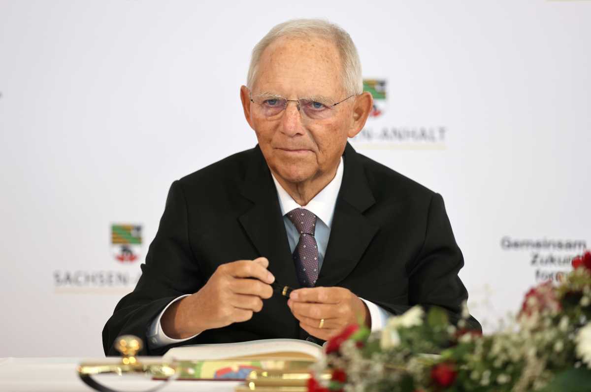 President of the Bundestag Wolfgang Schauble signs in the city's Golden Book before the start of a ceremony as part of celebrations for the 31st anniversary of Germany's Unification Day, in the city of Halle, Germany, October 3, 2021. Jan Woitas