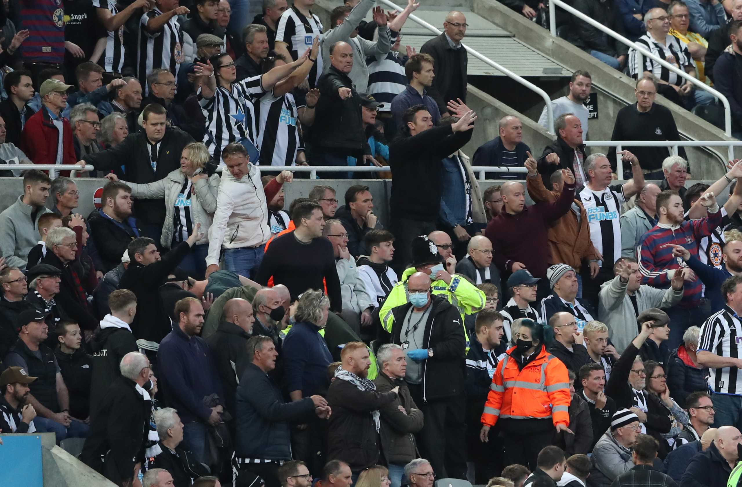 Soccer Football - Premier League - Newcastle United v Tottenham Hotspur - St James' Park, Newcastle, Britain - October 17, 2021  Newcastle United fans attract the attention of the officials to a medical emergency in the stands REUTERS