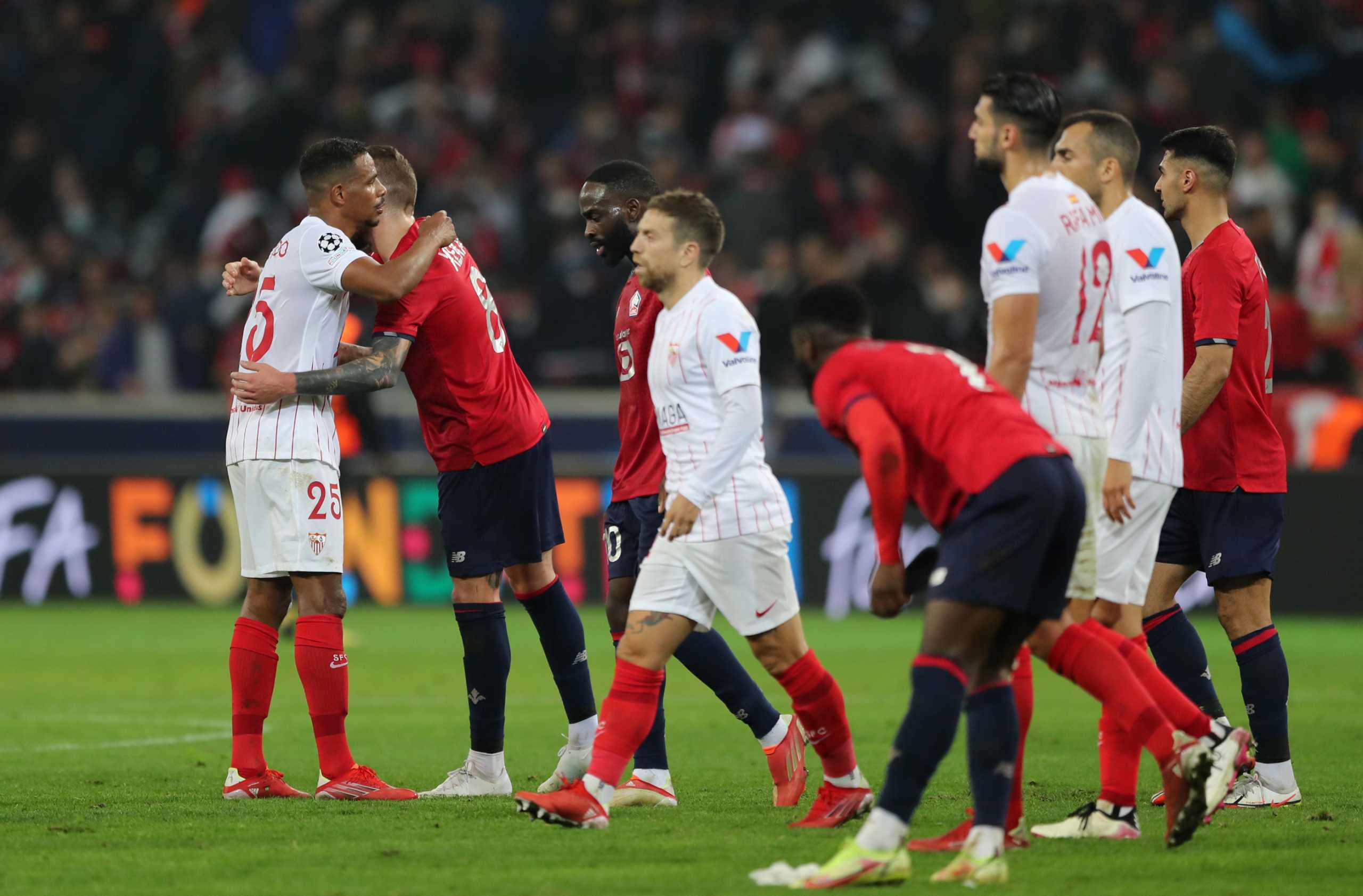Soccer Football - Champions League - Group G - Lille v Sevilla - Stade Pierre-Mauroy, Lille, France - October 20, 2021 Sevilla's Fernando shakes hands with Lille's Xeka after the match REUTERS