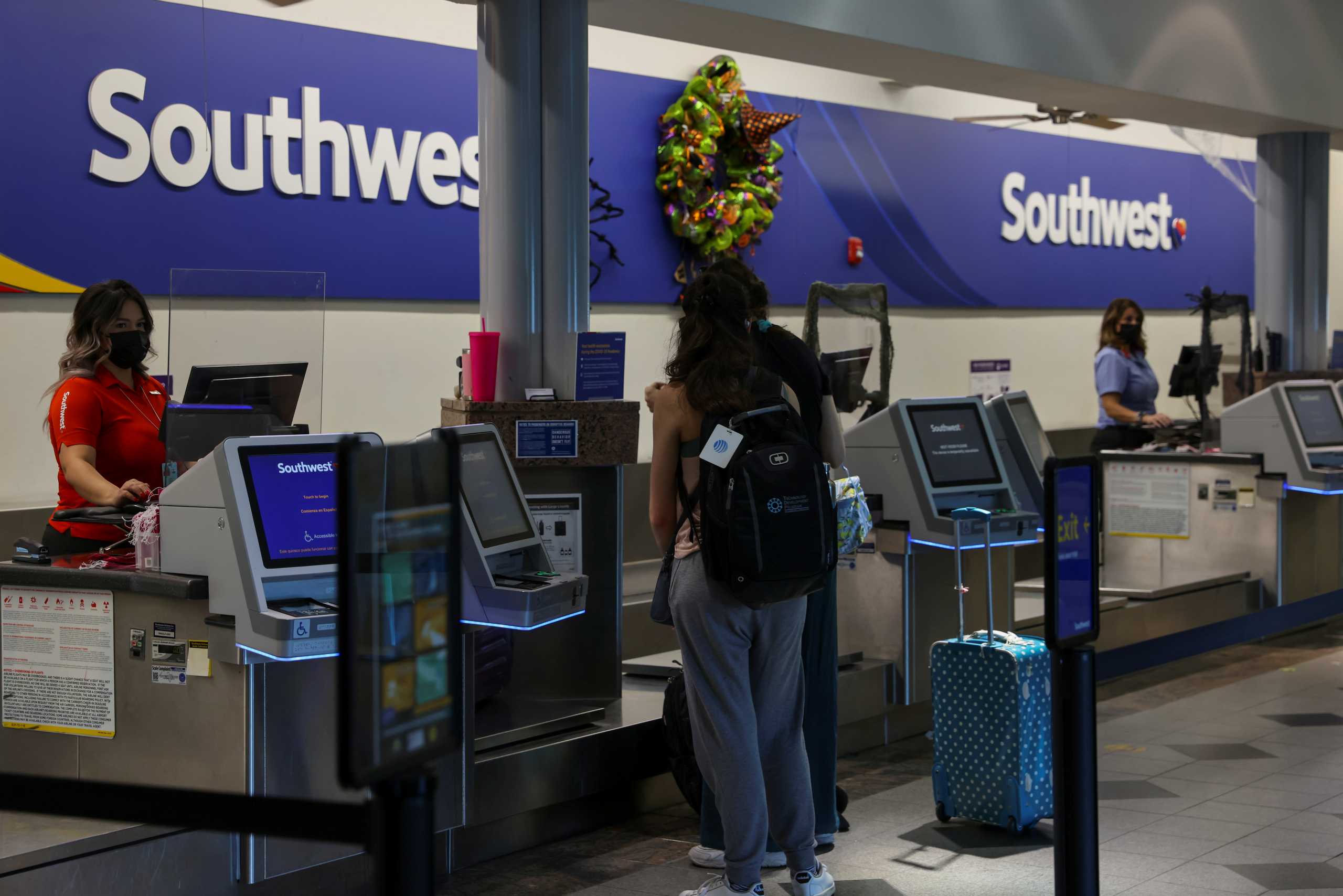 Southwest ticket agents work the departure counter at the airport in El Paso, Texas, U.S., October 11, 2021.      REUTERS