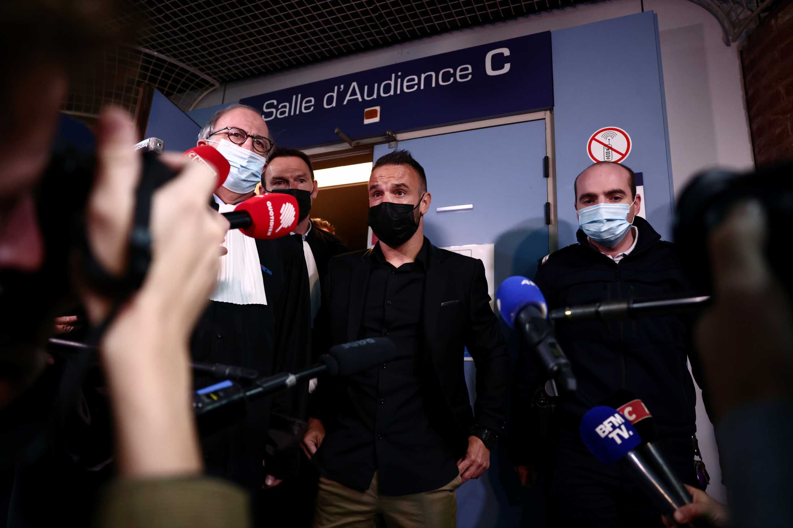 French soccer player Mathieu Valbuena and his lawyer Paul-Albert Iweins answer questions to journalists during a break in the trial of Real Madrid soccer team player Karim Benzema and other defendants, on charges of involvement in an alleged attempt to blackmail Valbuena over a sex tape almost five years ago, at the Versailles courthouse, near Paris, France, October 20, 2021. REUTERS
