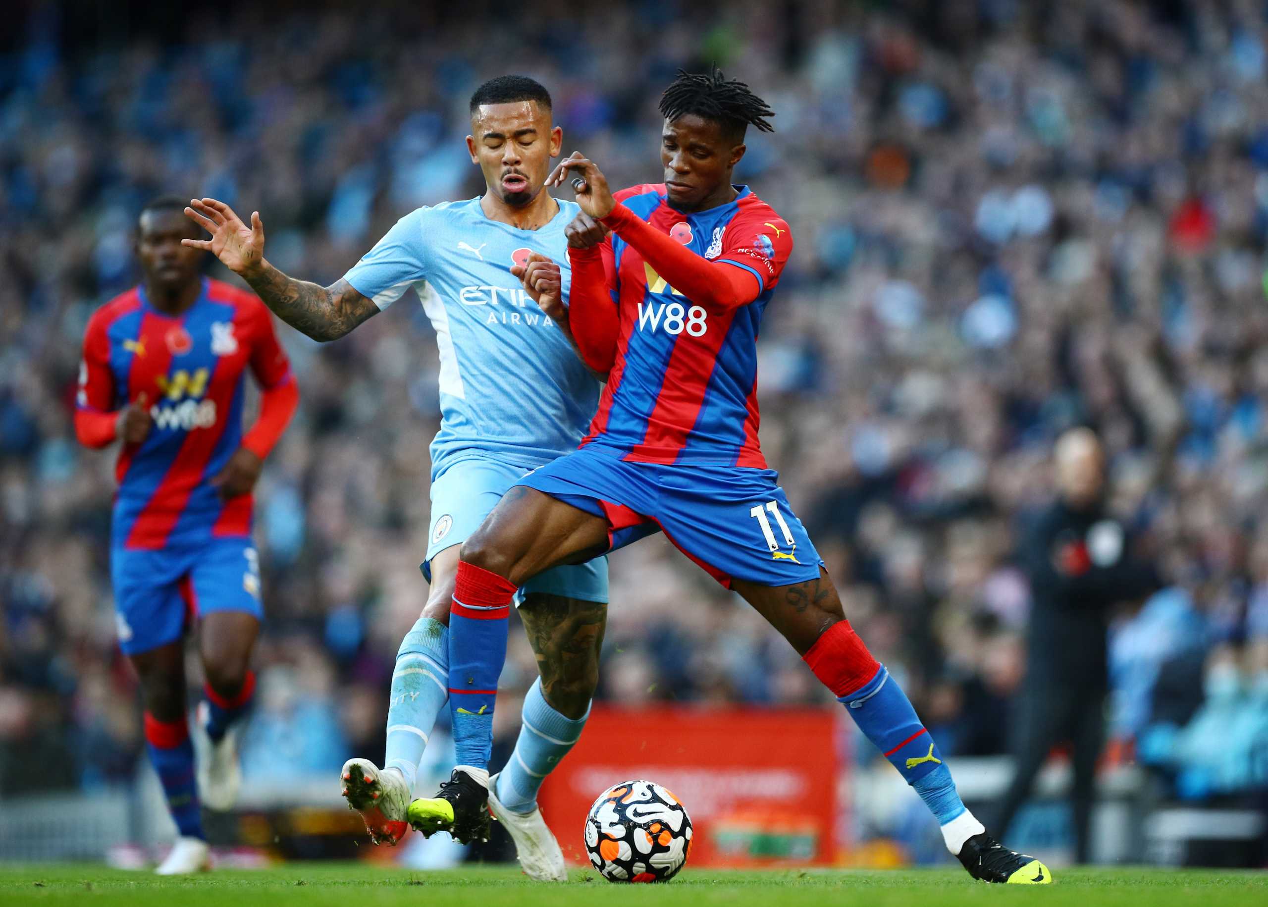 Soccer Football - Premier League - Manchester City v Crystal Palace - Etihad Stadium, Manchester, Britain - October 30, 2021 Crystal Palace's Wilfried Zaha in action with Manchester City's Gabriel Jesus REUTERS