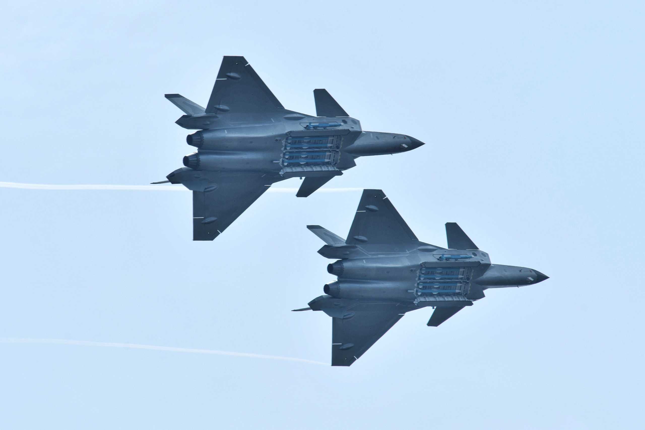 FILE PHOTO: Chengdu J-20 stealth fighter jets of Chinese People's Liberation Army (PLA) Air Force perform with open weapon bays during the China International Aviation and Aerospace Exhibition, or Zhuhai Airshow, in Zhuhai, Guangdong province, China November 11, 2018. REUTERS