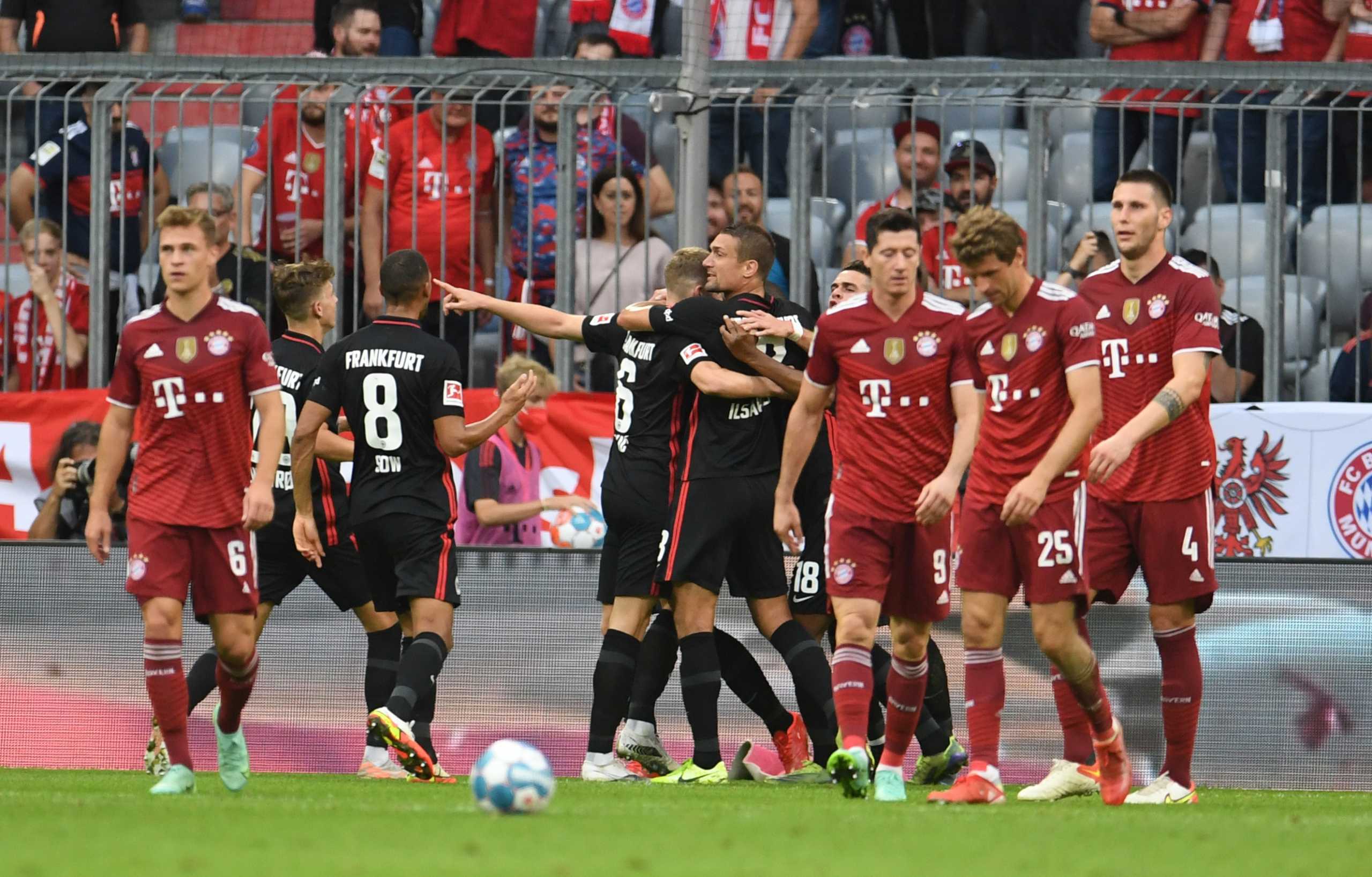 Soccer Football - Bundesliga - Bayern Munich v Eintracht Frankfurt - Allianz Arena, Munich, Germany - October 3, 2021 Eintracht Frankfurt's Martin Hinteregger celebrates scoring their first goal with teammates as Bayern Munich players look dejected REUTERS