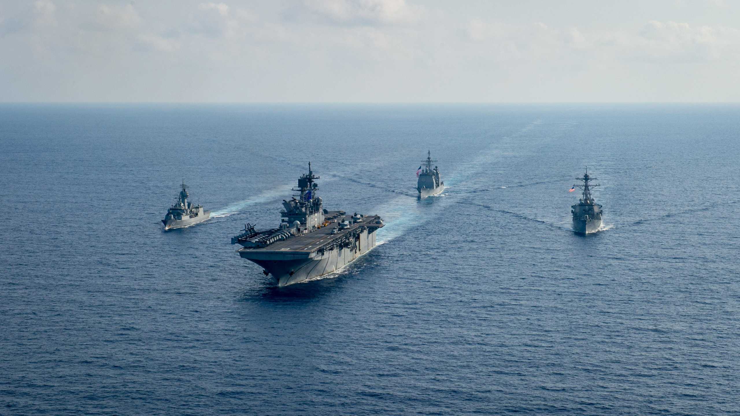 Royal Australian Navy guided-missile frigate HMAS Parramatta (FFH 154) (L) sails with U.S. Navy Amphibious assault ship USS America (LHA 6), Ticonderoga-class guided-missile cruiser USS Bunker Hill (CG 52) and Arleigh-Burke class guided missile destroyer USS Barry (DDG 52) in the South China Sea, April 18, 2020. Picture taken April 18, 2020.   Petty Officer 3rd Class Nicholas Huynh