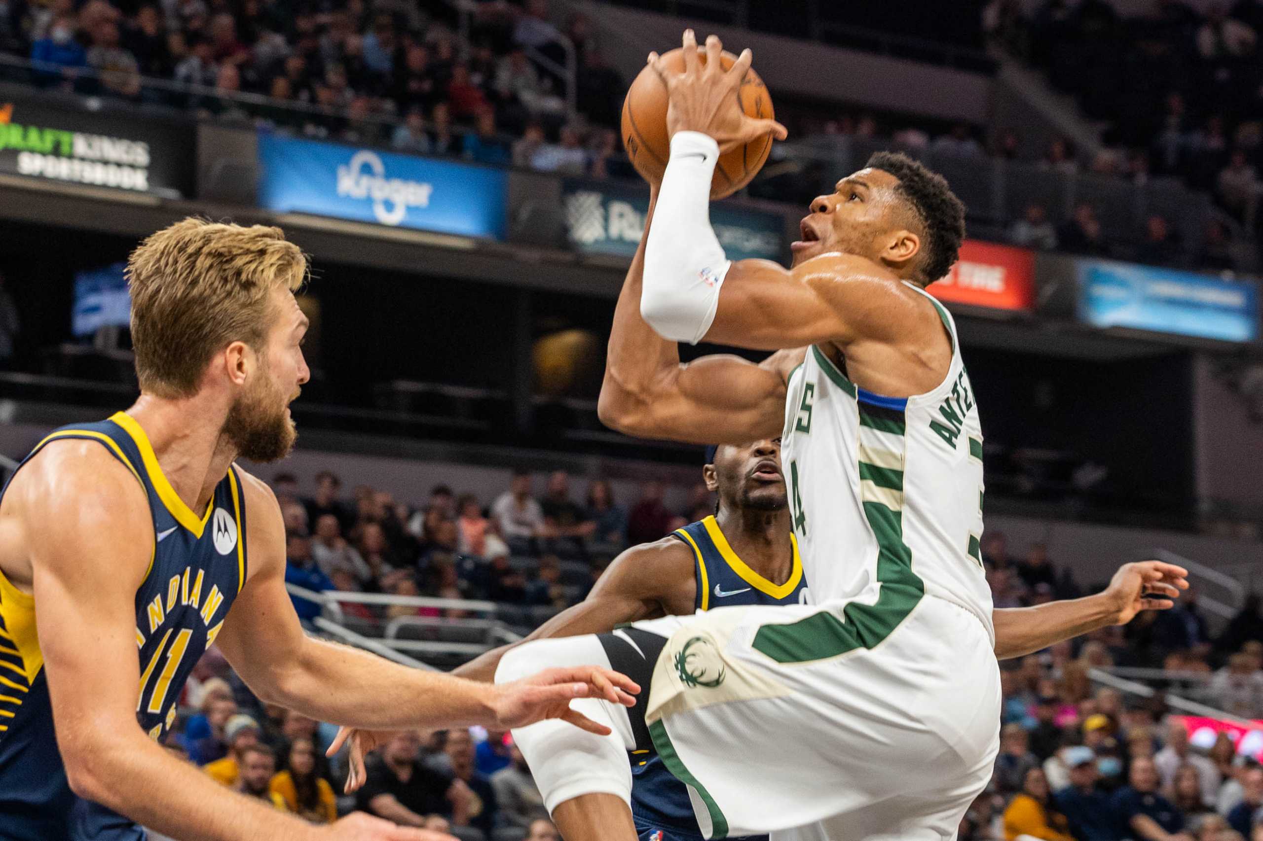 Oct 25, 2021; Indianapolis, Indiana, USA; Milwaukee Bucks forward Giannis Antetokounmpo (34) shoots the ball while Indiana Pacers forward Domantas Sabonis (11) defends in the first quarter at Gainbridge Fieldhouse. Mandatory Credit: Trevor Ruszkowski-USA TODAY Sports
