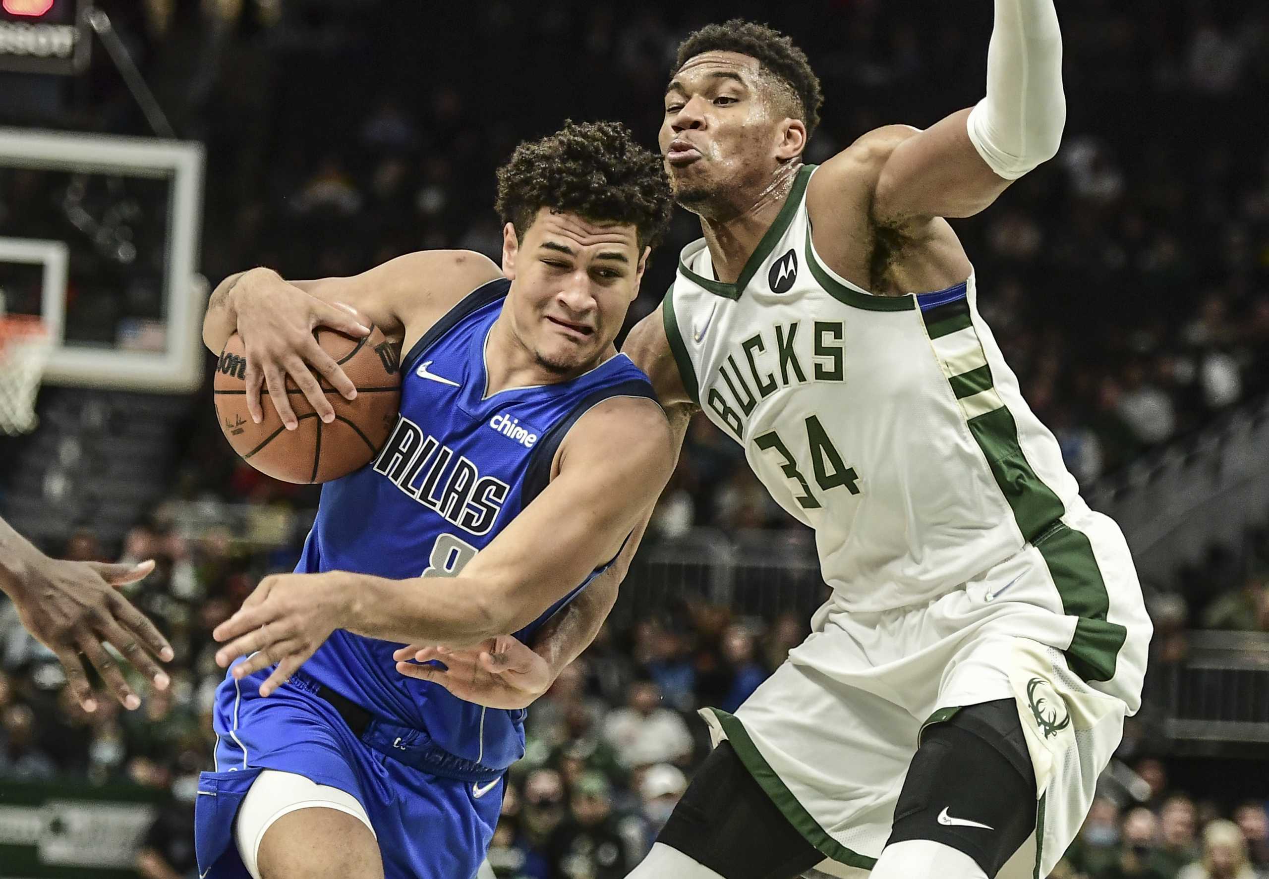 Oct 15, 2021; Milwaukee, Wisconsin, USA;  Dallas Mavericks guard Josh Green (8) drives for the basket against Milwaukee Bucks forward Giannis Antetokounmpo (34) in the third quarter at Fiserv Forum. Mandatory Credit: Benny Sieu-USA TODAY Sports