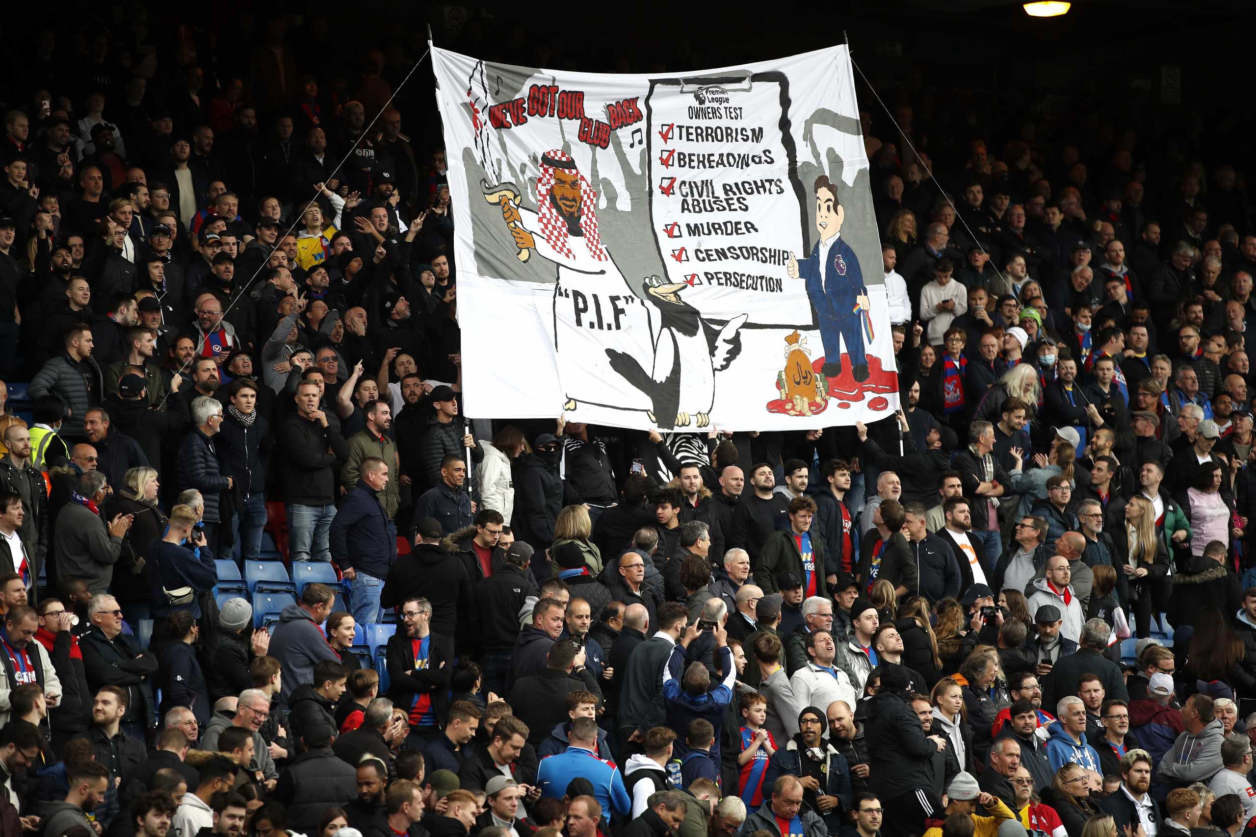 Soccer - England - Premier League - Crystal Palace v Newcastle United - Selhurst Park, London, Britain - October 23, 2021 Crystal Palace fans with a banner about Newcastle United's takeover before the match REUTERS