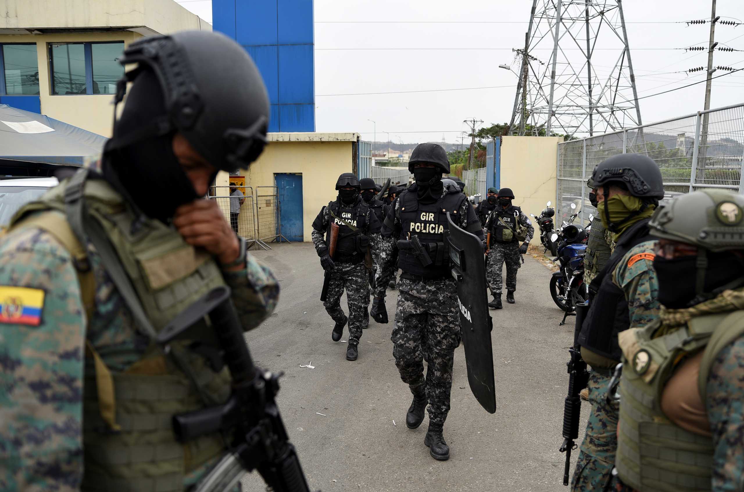Members of the special police Intervention and Rescue unit (GIR) walk out the Regional de Guayaquil prison after unrest was reported since the country's worst-ever riots broke out a few days ago at the Penitenciaria del Litoral, in Guayaquil, Ecuador October 2, 2021. REUTERS