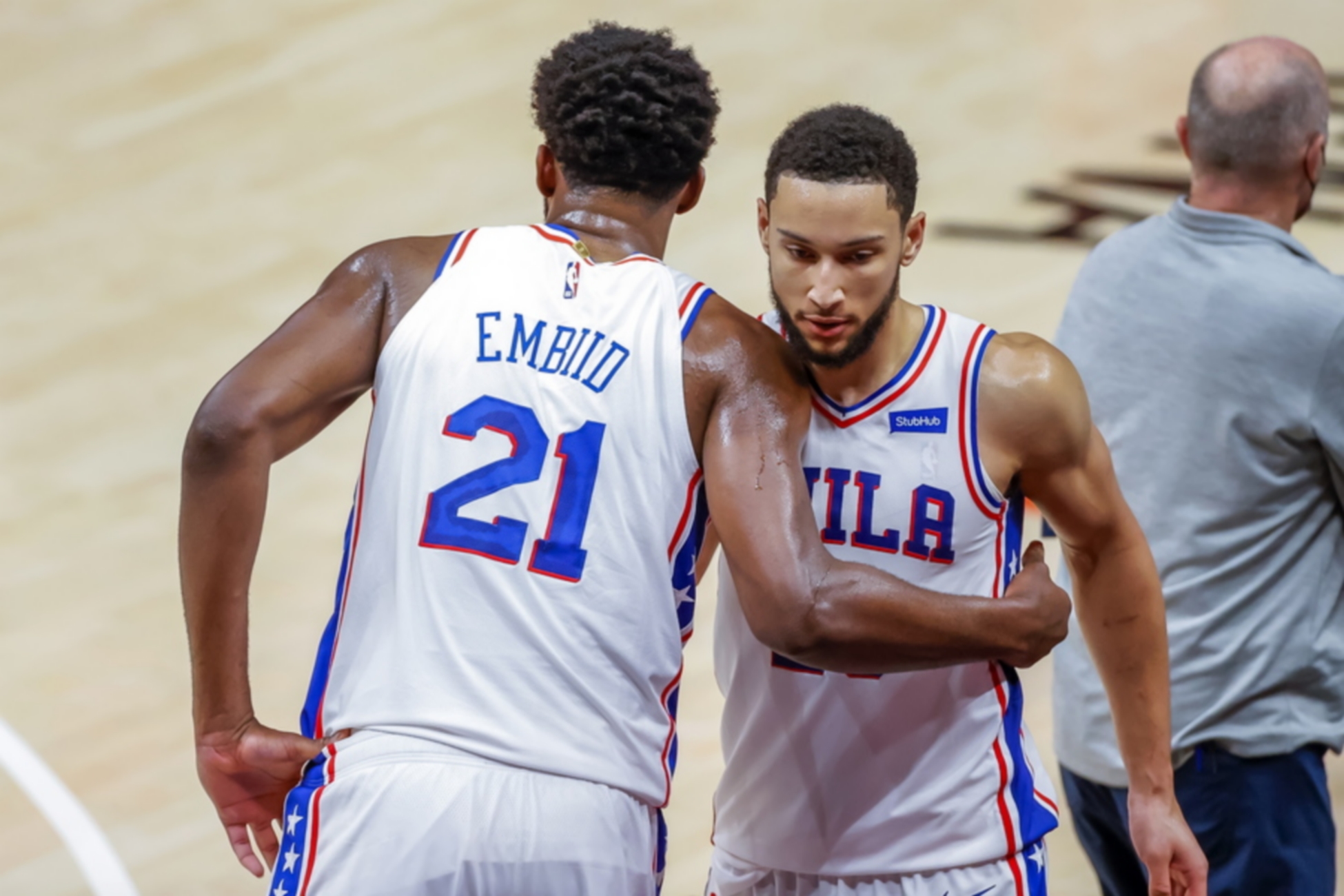 epa09263777 Philadelphia 76ers center Joel Embiid (L) of Cameroon reacts with Philadelphia 76ers guard Ben Simmons (R) of Australia during the second half of game three of the NBA Eastern Conference semifinal round round playoff series between the Philadelphia 76ers and the Atlanta Hawks at State Farm Arena in Atlanta, Georgia, USA, 11 June 2021.  EPA