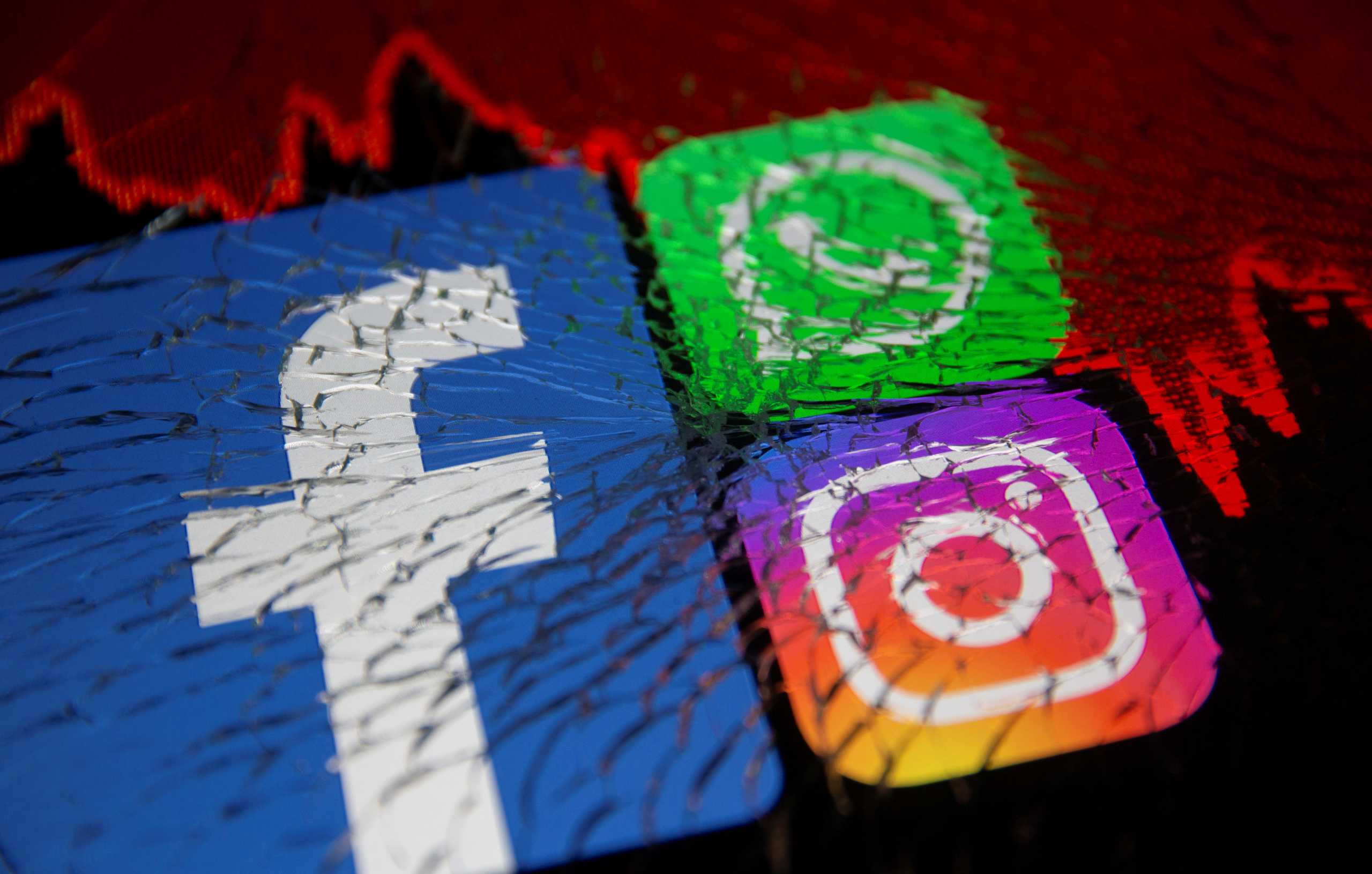 Facebook, Whatsapp and Instagram logos and stock graph are displayed through broken glass in this illustration taken October 4, 2021. REUTERS