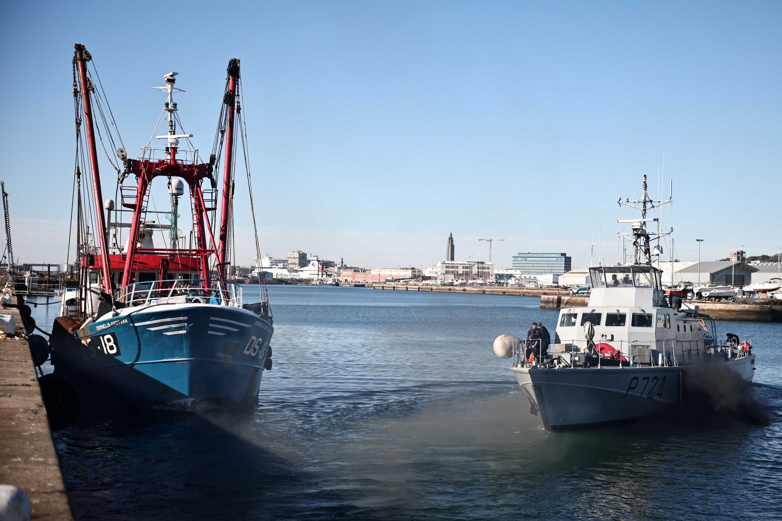 The French Gendarmerie patrol boat Athos leaves as a British trawler Cornelis Gert Jan is seen moored in the port of Le Havre after France seized on Thursday a British trawler fishing in its territorial waters without a licence, in Le Havre, France, October 28, 2021. REUTERS