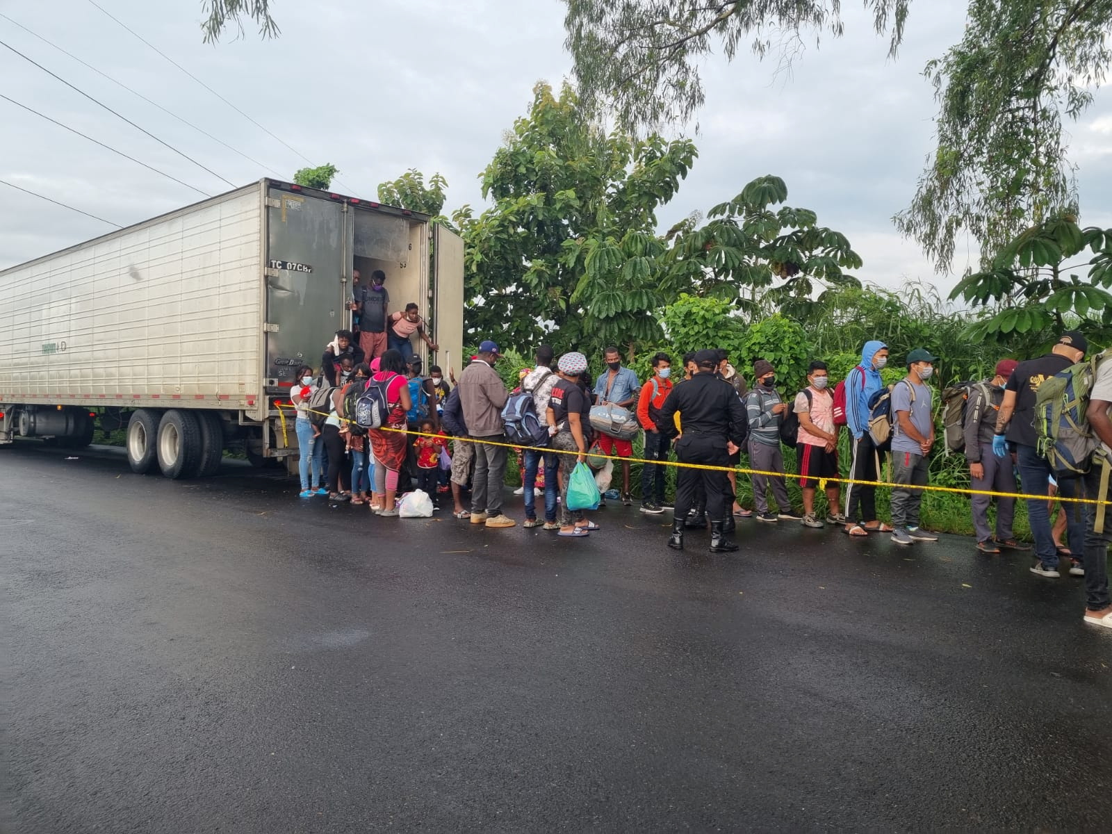 Migrants traveling in a cargo truck in an attempt to reach the U.S. border get off after the truck was stopped by Guatemala's National Civil Police (PNC), in Mazatenango, Guatemala, in this undated photograph obtained by Reuters on October 9, 2021. Guatemala's National Civil Police