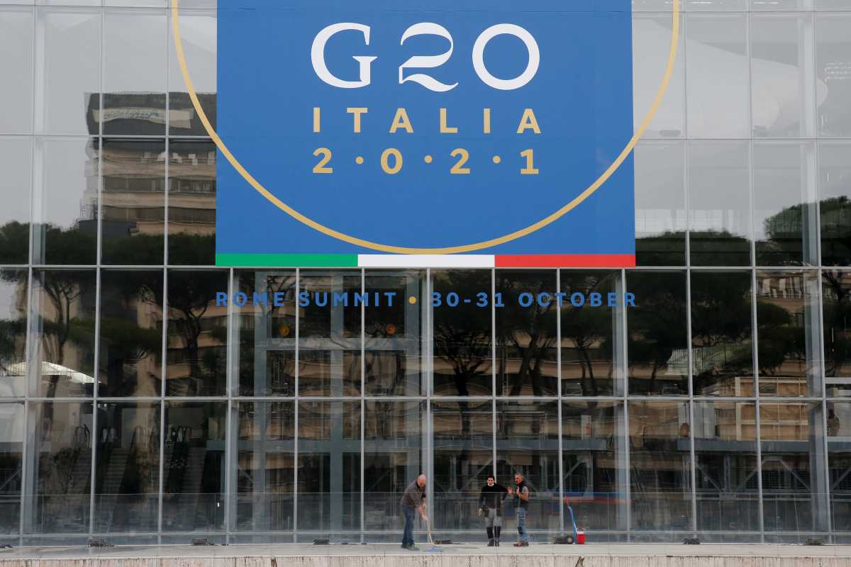 Workers clean in front of the Rome Convention Centre 'La Nuvola', in the city's EUR district, that will host the G20 summit with heads of state from major nations for a two-day meeting from October 30-31, in Rome, Italy, October 22, 2021. REUTERS