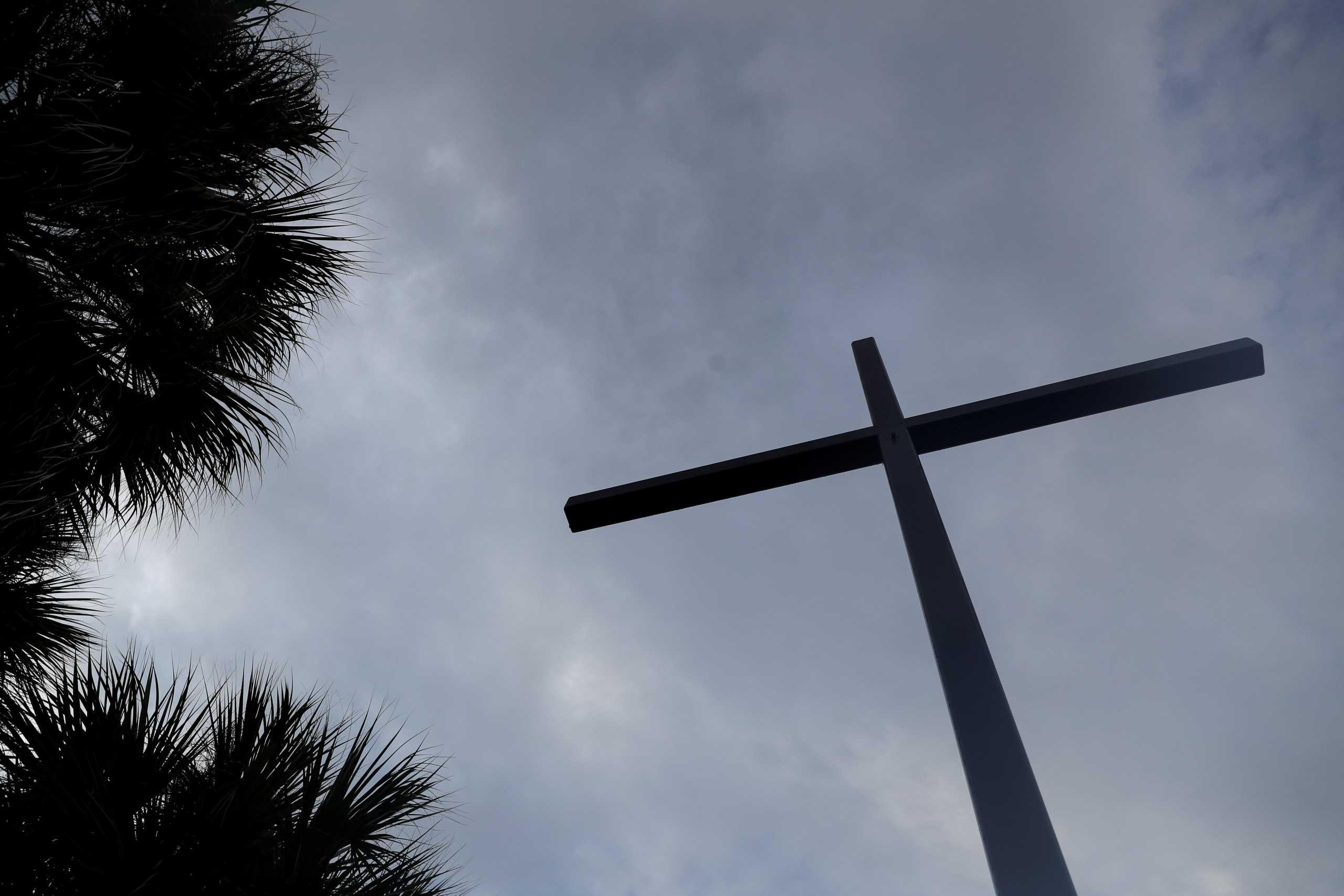 A religious cross stands outside the San Antonio Catholic Church in Port Charlotte, Florida, U.S., September 20, 2021. REUTERS