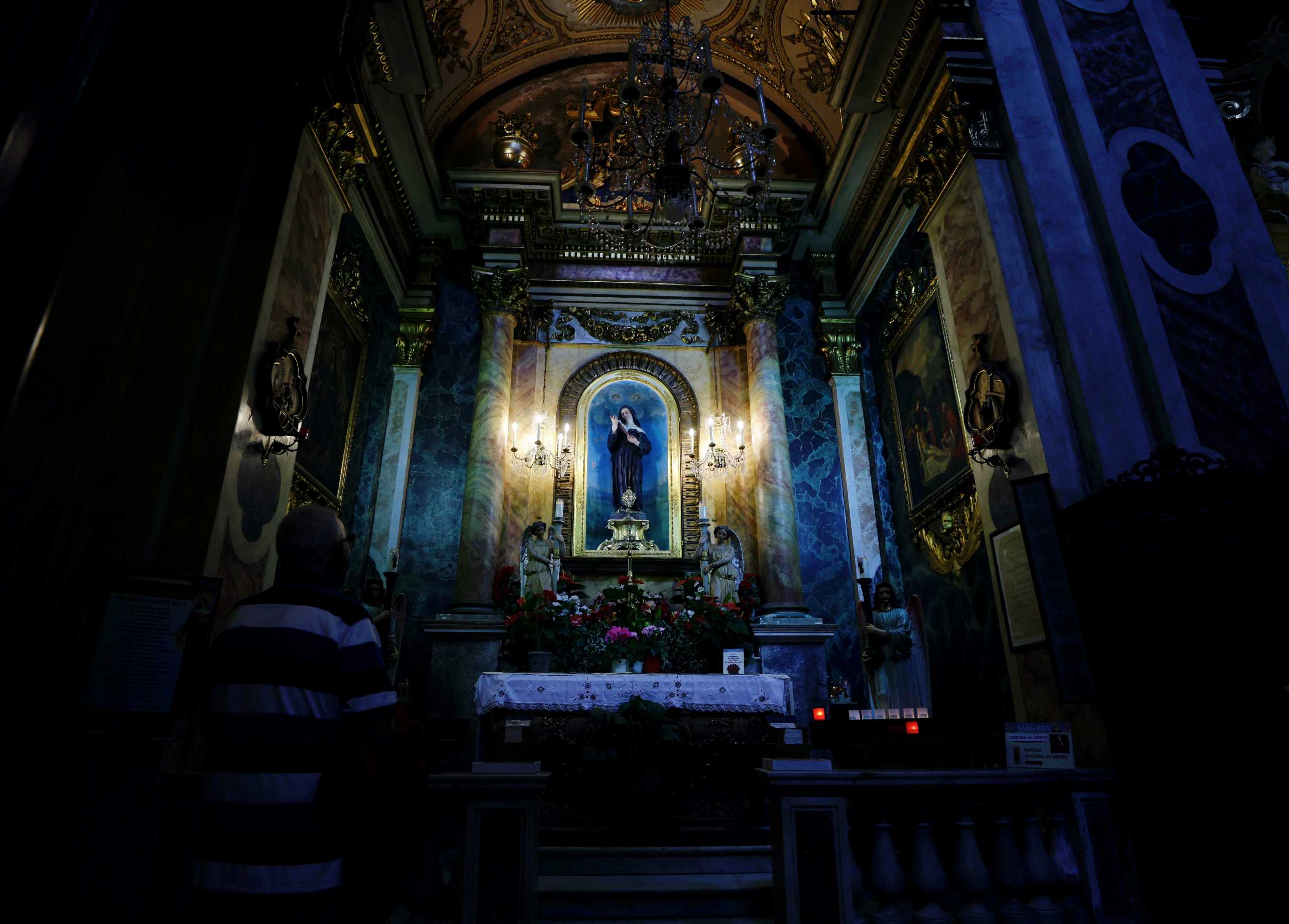 A man prays in Notre-Dame Basilica in Nice, France, October 4, 2021.  REUTERS