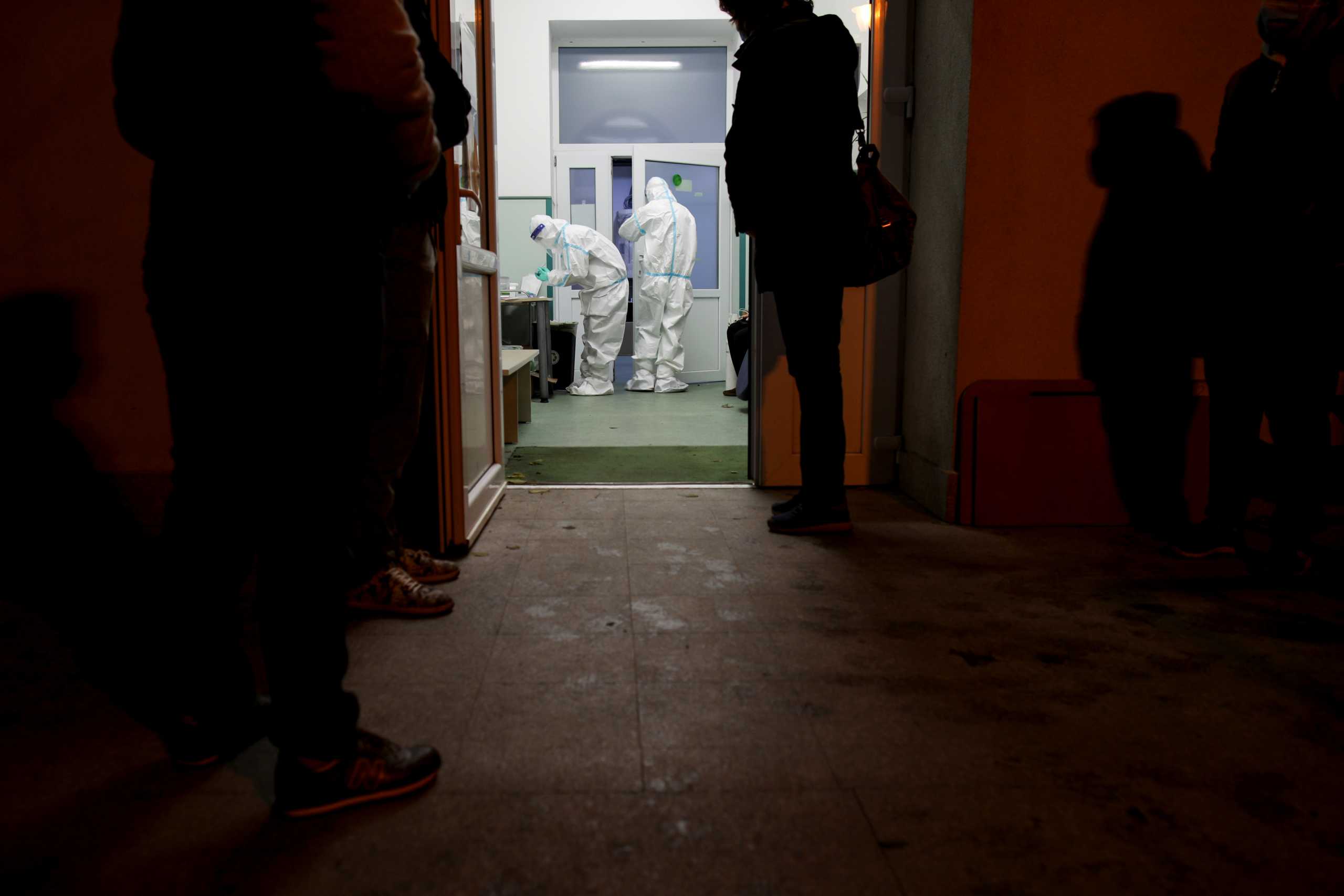 Nurses prepare medical papers while people wait outside to be admitted in the coronavirus disease (COVID-19) ward of Marius Nasta Pneumology Institute in Bucharest, Romania, October 17, 2021. Picture taken October 17, 2021. Inquam Photos