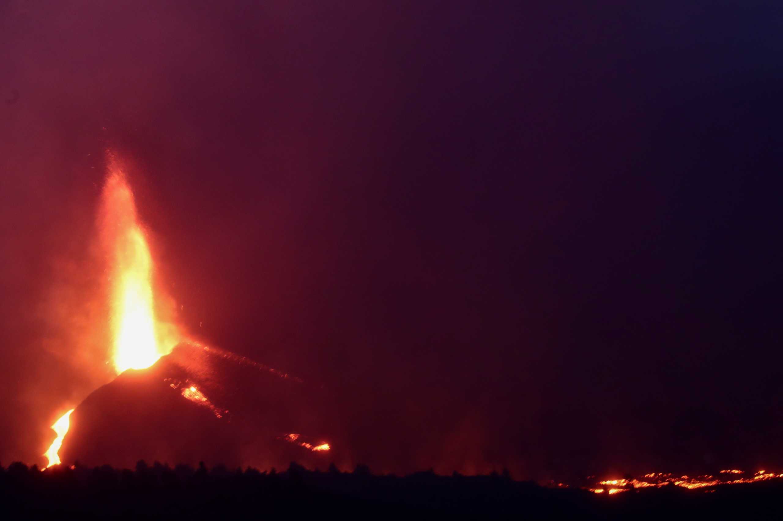 Lava rolls down as the Cumbre Vieja volcano continues to erupt on the Canary Island of La Palma, as seen from Tajuya, Spain, October 11, 2021. REUTERS