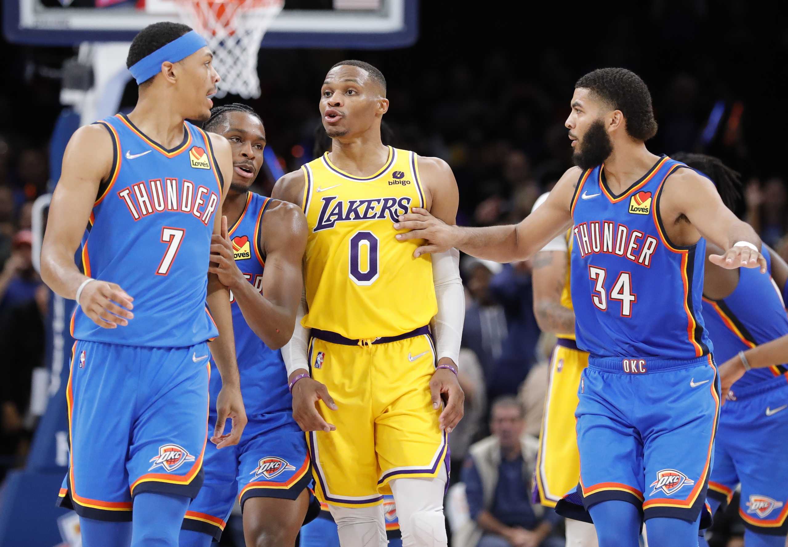 Oct 27, 2021; Oklahoma City, Oklahoma, USA; Los Angeles Lakers guard Russell Westbrook (0) has words with Oklahoma City Thunder forward Darius Bazley (7) after scoring a basket during the second half at Paycom Center. Oklahoma City won 123-115. Mandatory Credit: Alonzo Adams-USA TODAY Sports