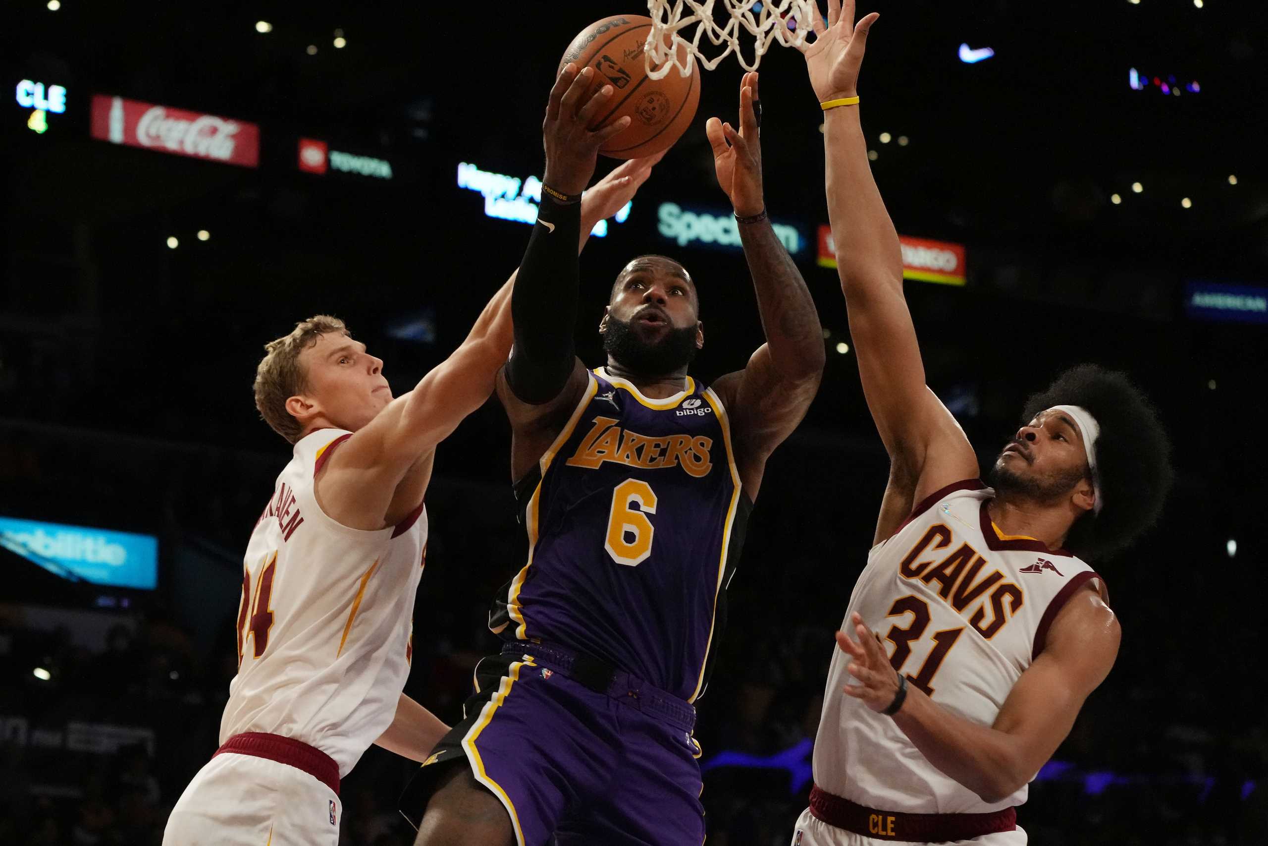 Oct 29, 2021; Los Angeles, California, USA; Los Angeles Lakers forward LeBron James (6) moves in for a basket against Cleveland Cavaliers forward Lauri Markkanen (24) and center Jarrett Allen (31) during the second half at Staples Center. Mandatory Credit: Kirby Lee-USA TODAY Sports