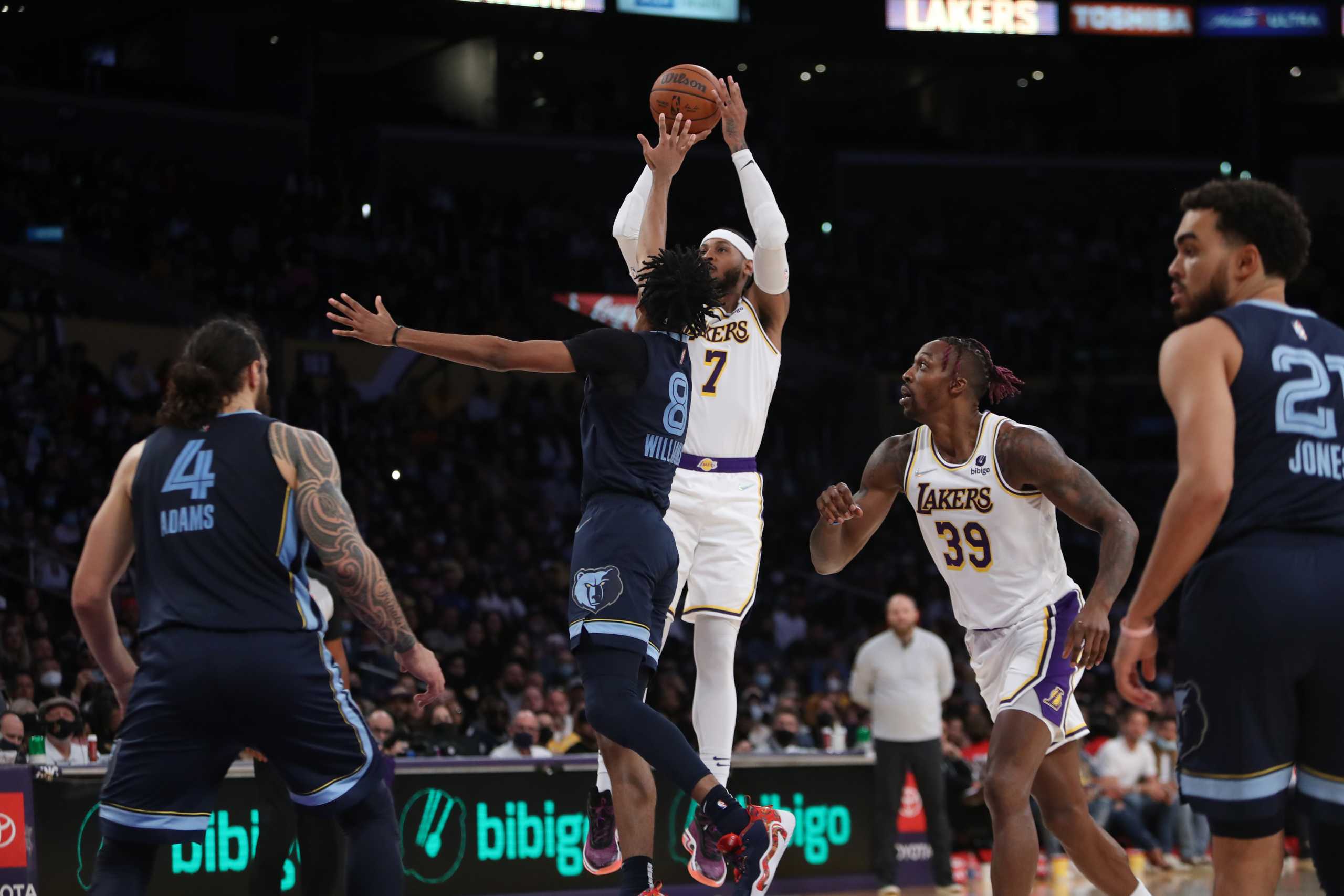 Oct 24, 2021; Los Angeles, California, USA; Los Angeles Lakers forward Carmelo Anthony (7) shoots a ball over Memphis Grizzlies guard Ziaire Williams (8) during the third quarter at Staples Center. The Lakers won 121-118. Mandatory Credit: Kiyoshi Mio-USA TODAY Sports