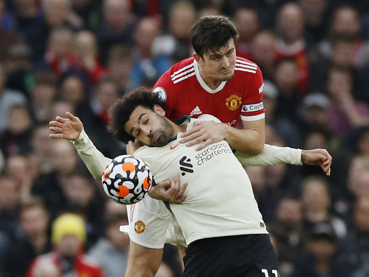 Soccer Football - Premier League - Manchester United v Liverpool - Old Trafford, Manchester, Britain - October 24, 2021 Manchester United's Harry Maguire in action with Liverpool's Mohamed Salah REUTERS