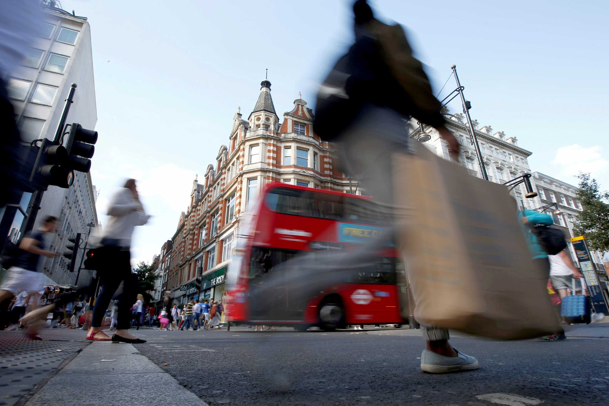 FILE PHOTO: Shoppers cross the road in Oxford Street, in London, Britain August 14, 2016.  REUTERS