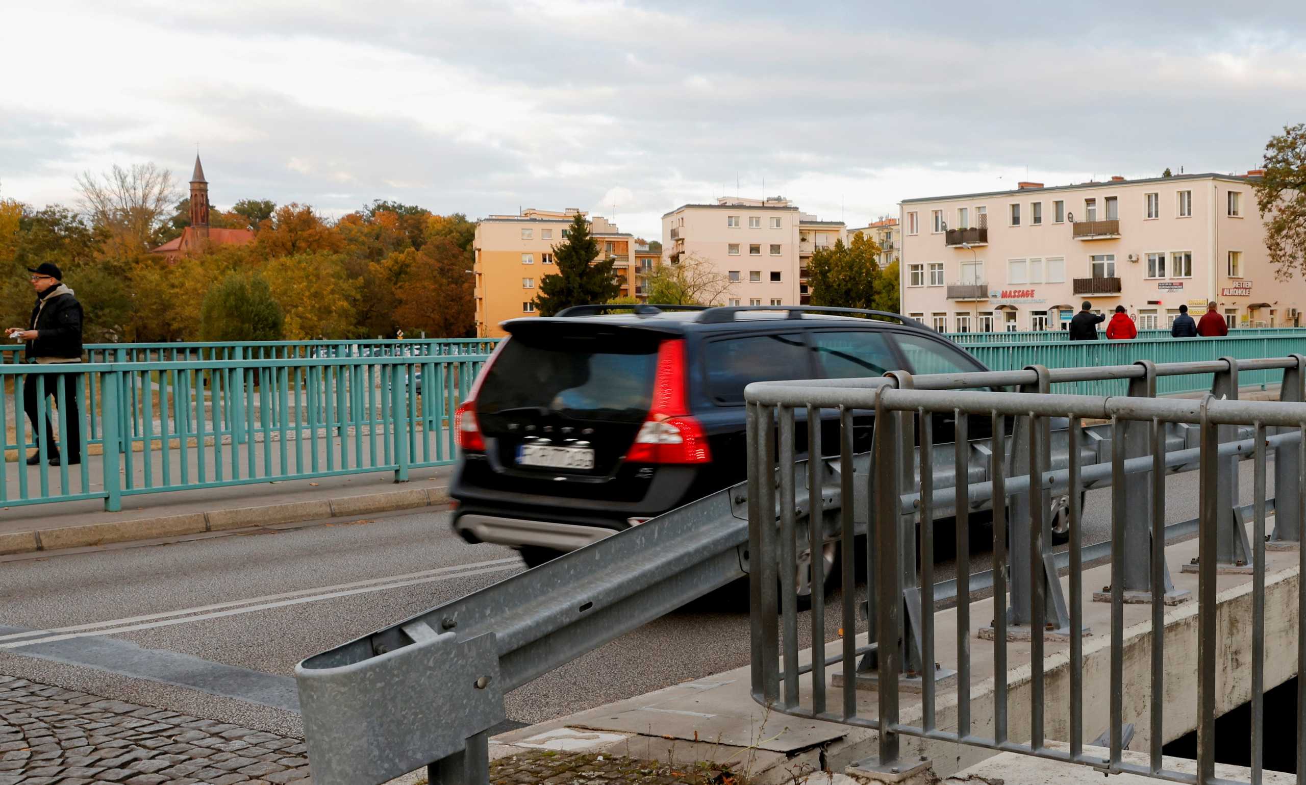 FILE PHOTO: People cross the border between Germany and Poland in Guben, Germany, October 23, 2021.     REUTERS