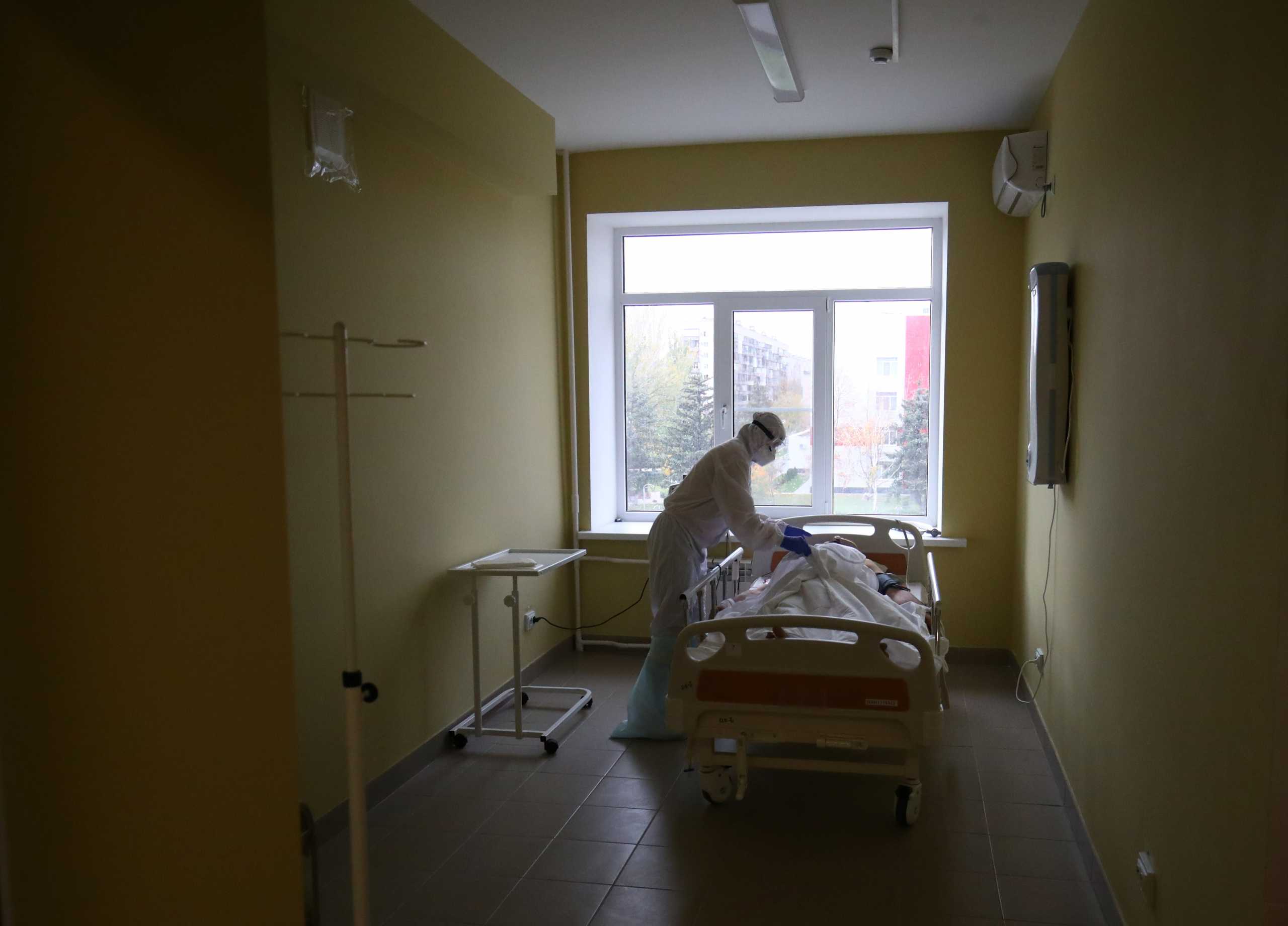 A medical specialist wearing protective gear tends to a patient at the City Clinical Hospital Number 1, where people suffering from the coronavirus disease (COVID-19) are treated, in Volzhsky, Russia October 25, 2021. REUTERS