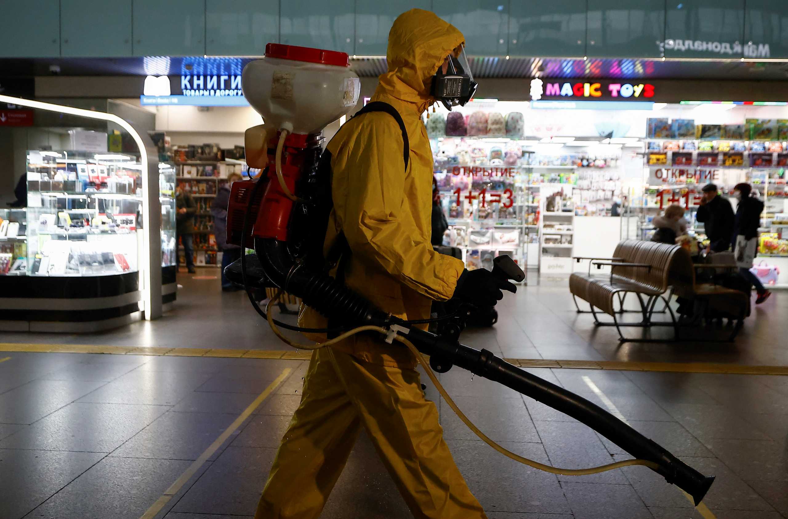 A specialist wearing personal protective equipment (PPE) sprays disinfectant while sanitizing the Leningradsky railway station amid the outbreak of the coronavirus disease (COVID-19) in Moscow, Russia October 19, 2021. REUTERS