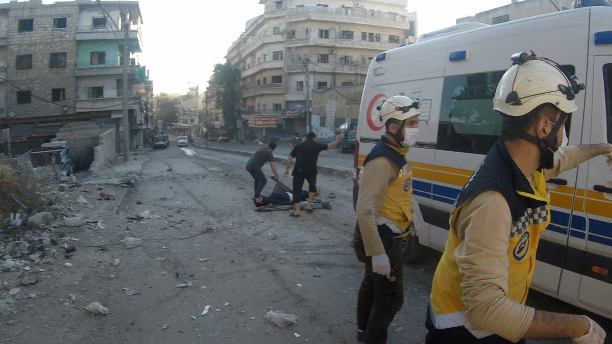 Men pick up a victim as White Helmets work in the aftermath of a Syrian army shelling of residential areas in rebel-held Ariha, Idlib, Syria October 20, 2021 in this handout image. Courtesy of White Helmets