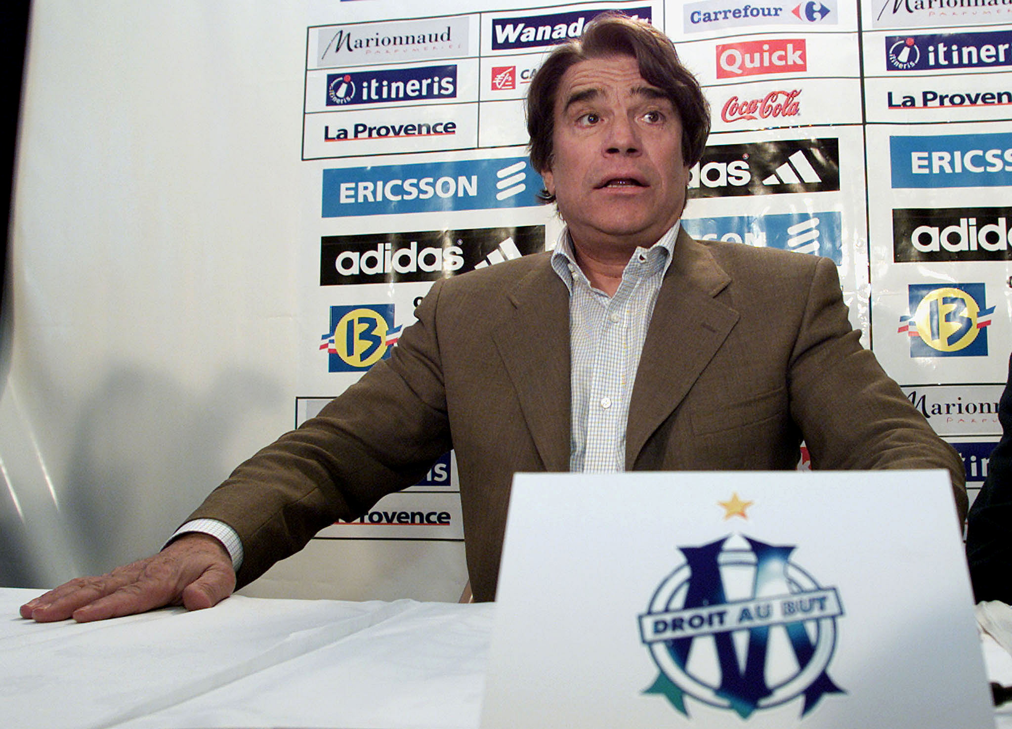 FILE PHOTO: Bernard Tapie, the former chairman of the French soccer team Olympique de Marseille, answers questions during a press conference in Marseille, April 9, 2001. REUTERS