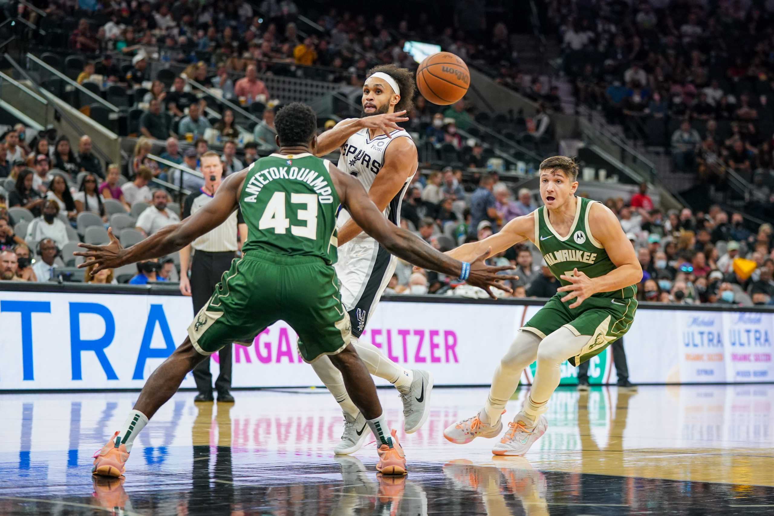 Oct 23, 2021; San Antonio, Texas, USA;  San Antonio Spurs guard Derrick White (4) passes the ball in front of Milwaukee Bucks forward Thanasis Antetokounmpo (43) in the second half at the AT&T Center. Mandatory Credit: Daniel Dunn-USA TODAY Sports