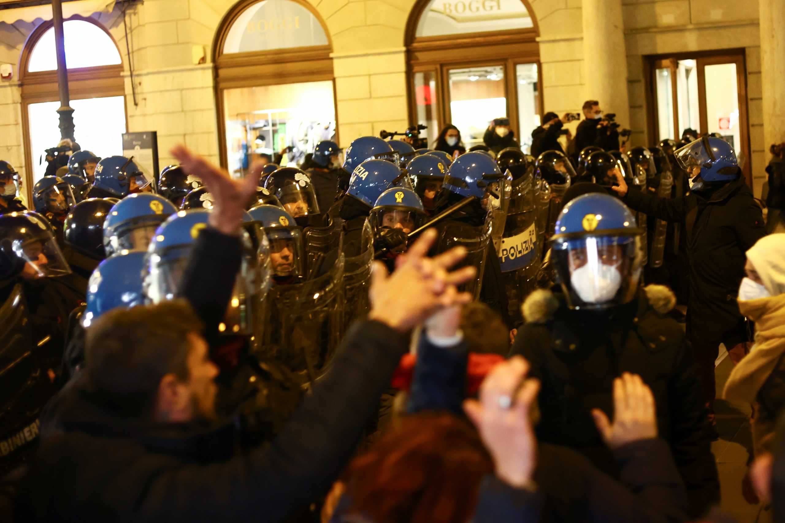 Protesters scuffle with police as they demonstrate against the mandatory use of the coronavirus disease (COVID-19) health pass, the Green Pass, in Trieste, Italy, November 6, 2021. REUTERS