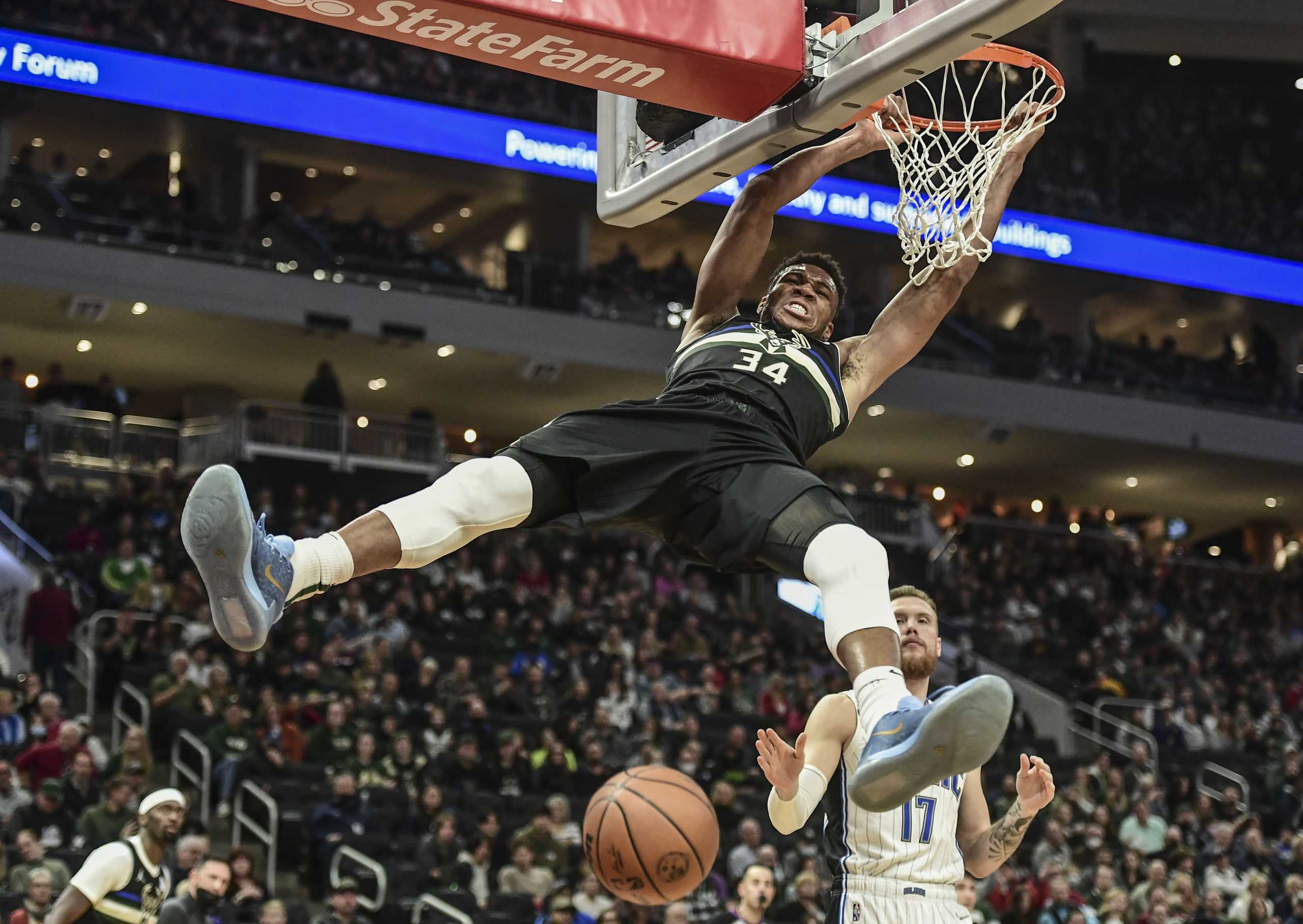 Nov 20, 2021; Milwaukee, Wisconsin, USA; Milwaukee Bucks forward Giannis Antetokounmpo (34) dunks a basket against Orlando Magic forward Ignas Brazdeikis (17) in the second quarter at Fiserv Forum. Mandatory Credit: Benny Sieu-USA TODAY Sports
