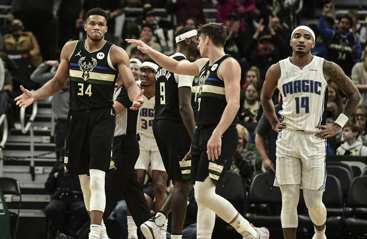 Nov 20, 2021; Milwaukee, Wisconsin, USA;  Milwaukee Bucks forward Giannis Antetokounmpo (34) celebrates with guard Grayson Allen (7) after scoring a basket in the third quarter as Orlando Magic guard Gary Harris (14) looks on at Fiserv Forum. Mandatory Credit: Benny Sieu-USA TODAY Sports