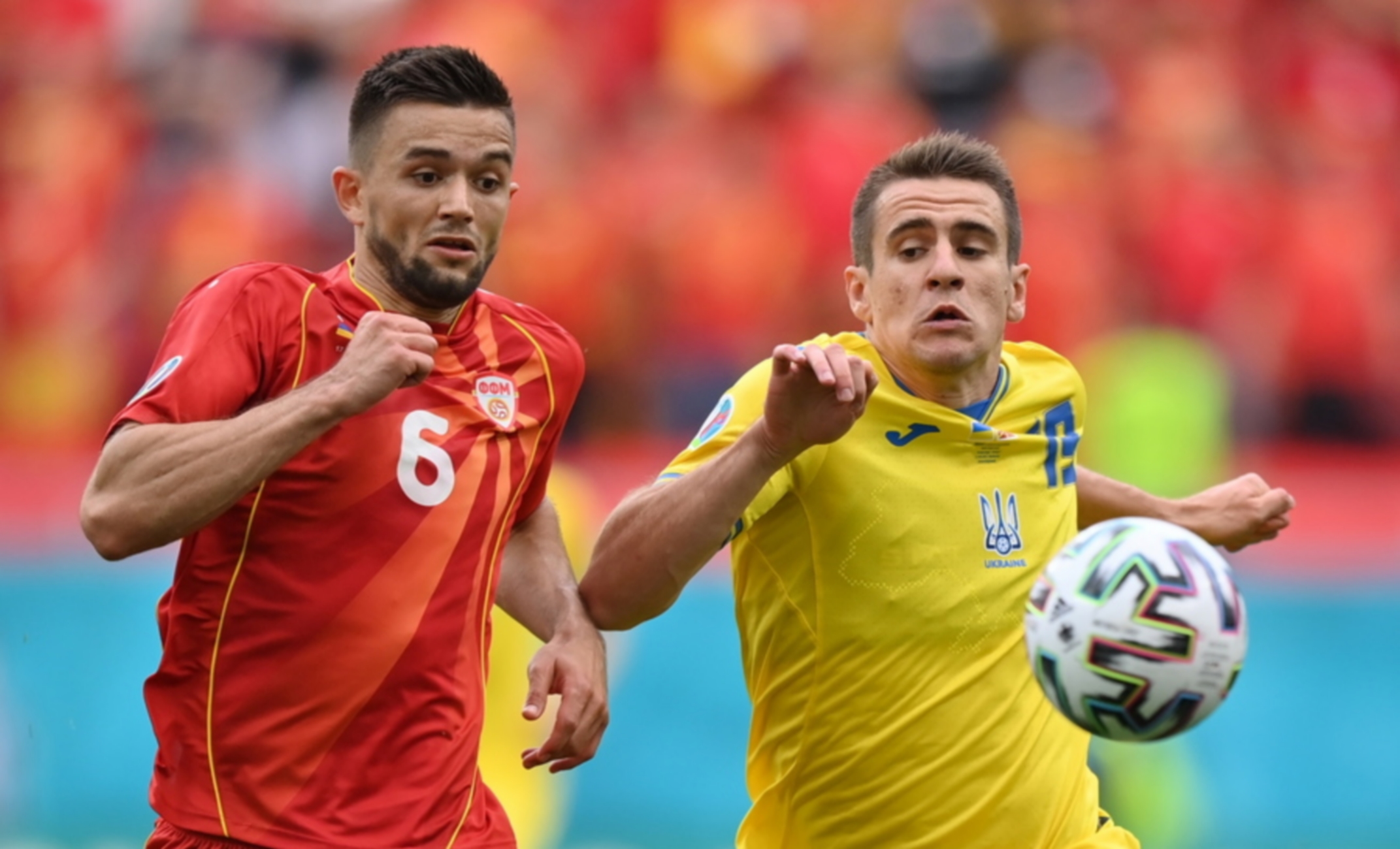 epa09279738 Artem Besyedin (R) of Ukraine in action against Visar Musliu of North Macedonia during the UEFA EURO 2020 group C preliminary round soccer match between Ukraine and North Macedonia in Bucharest, Romania, 17 June 2021.  EPA