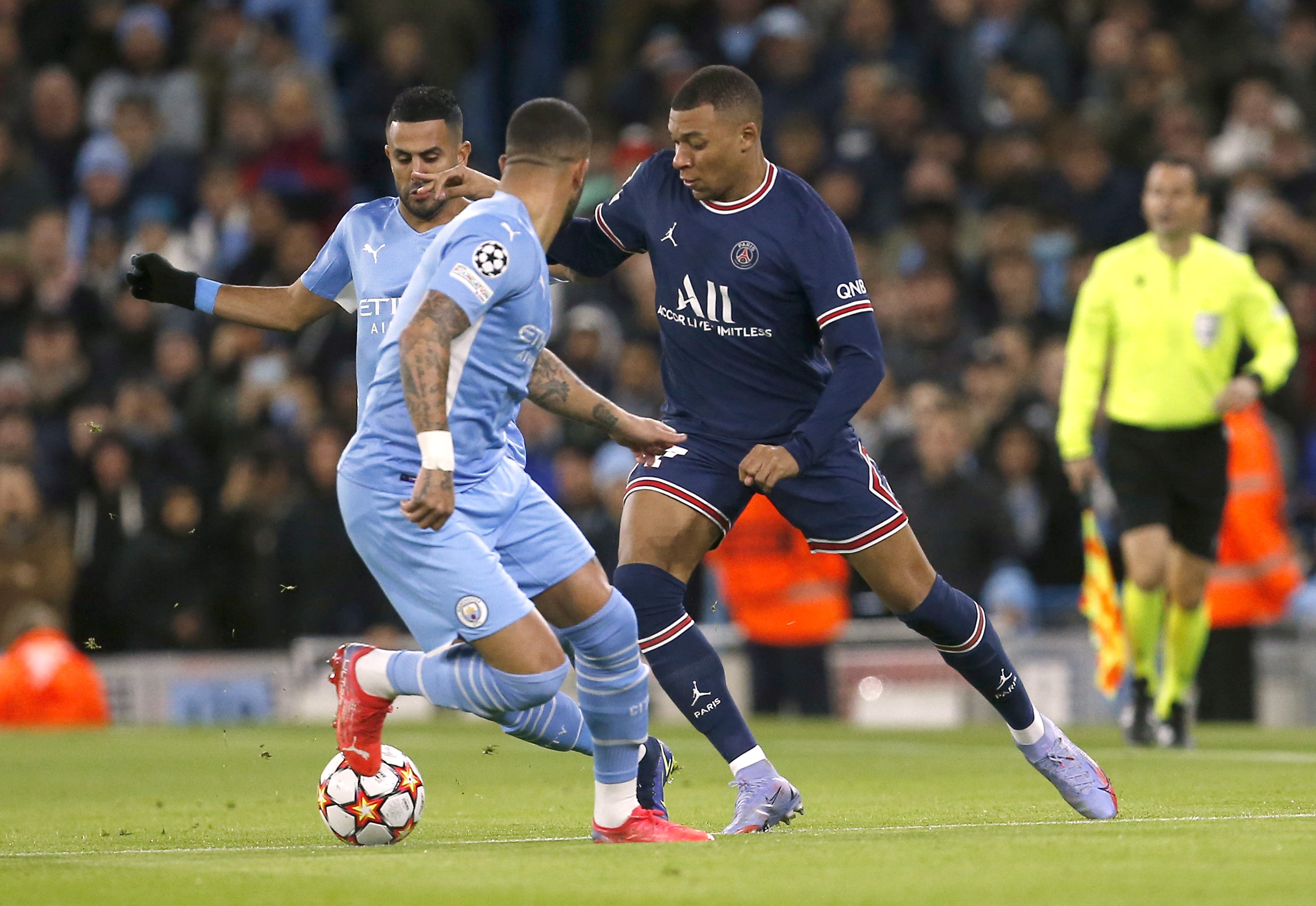 Soccer Football - Champions League - Group A - Manchester City v Paris St Germain - Etihad Stadium, Manchester, Britain - November 24, 2021 Paris St Germain's Kylian Mbappe in action with Manchester City's Riyad Mahrez and Kyle Walker REUTERS