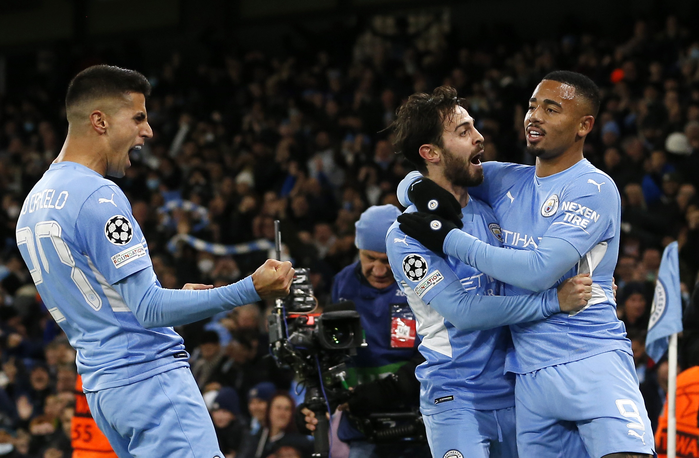 Soccer Football - Champions League - Group A - Manchester City v Paris St Germain - Etihad Stadium, Manchester, Britain - November 24, 2021 Manchester City's Gabriel Jesus celebrates scoring their second goal with Bernardo Silva and Joao Cancelo REUTERS