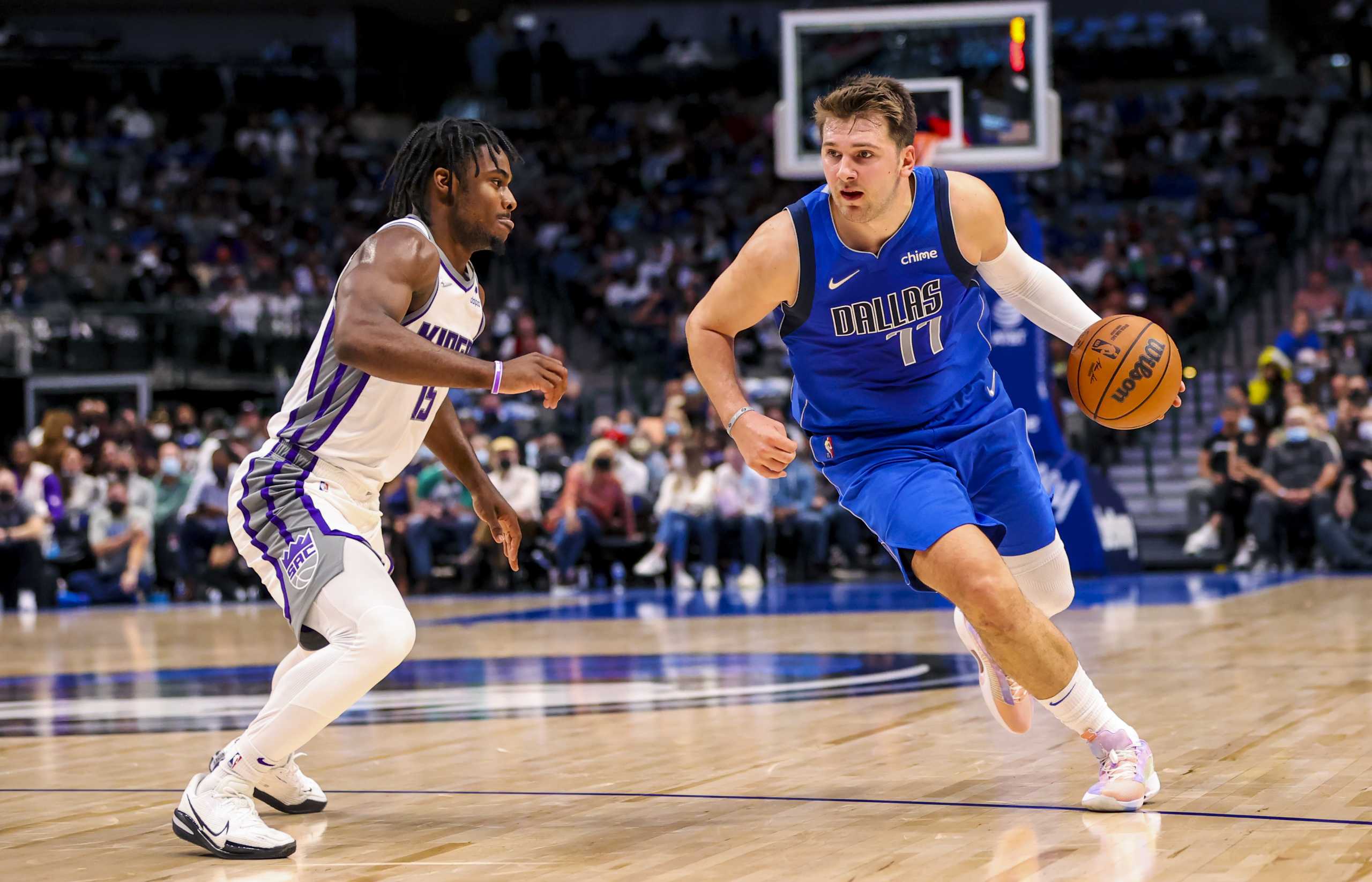 Oct 31, 2021; Dallas, Texas, USA;  Dallas Mavericks guard Luka Doncic (77) dribbles as Sacramento Kings guard Davion Mitchell (15) defends during the first half at American Airlines Center. Mandatory Credit: Kevin Jairaj-USA TODAY Sports