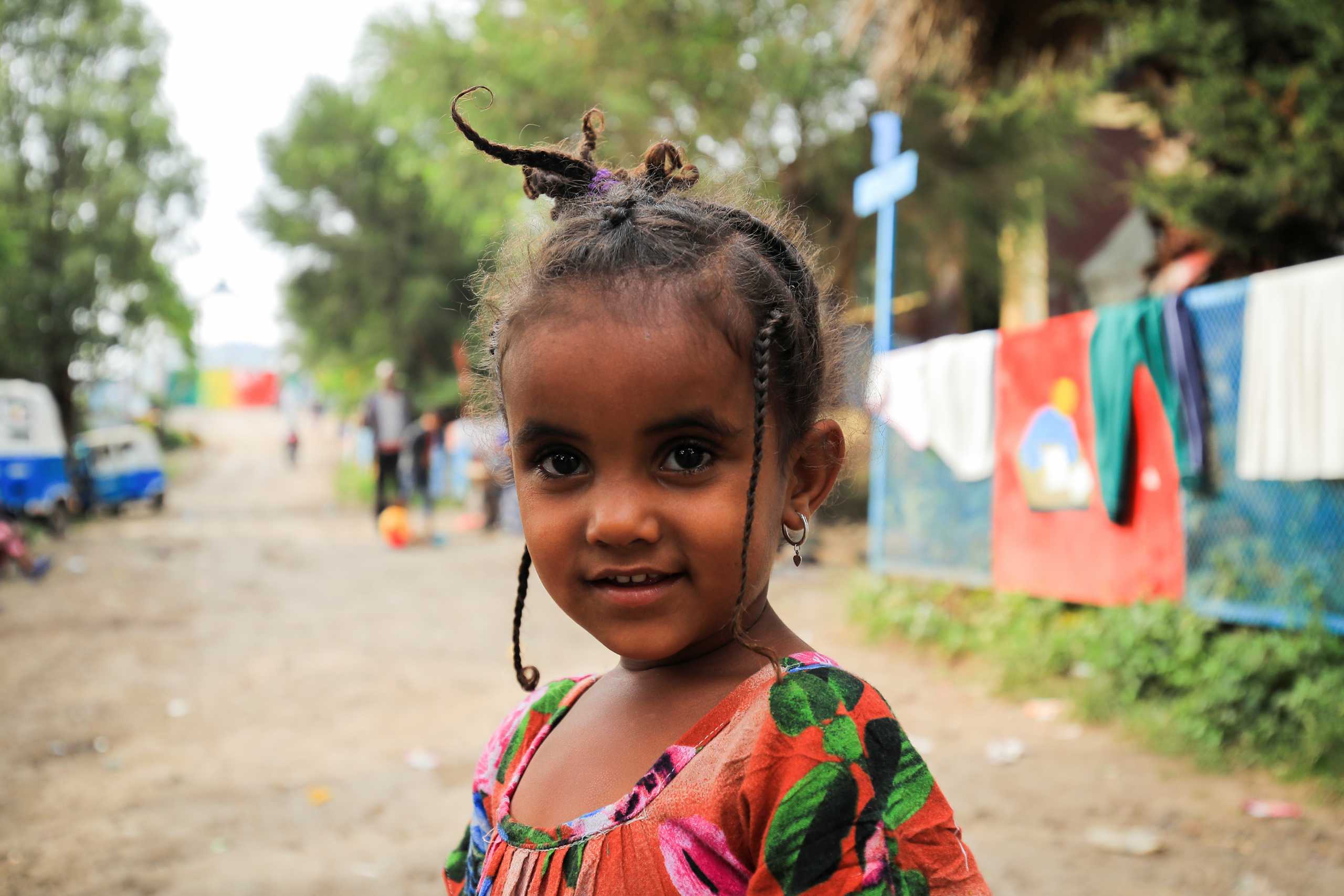 A girl plays in front of her shelter at a camp for the internally displaced due to the fighting between the Ethiopian National Defense Force (ENDF) and the Tigray People's Liberation Front (TPLF) forces in Dessie town, Amhara Region, Ethiopia, October 8, 2021. Picture taken October 8, 2021. REUTERS